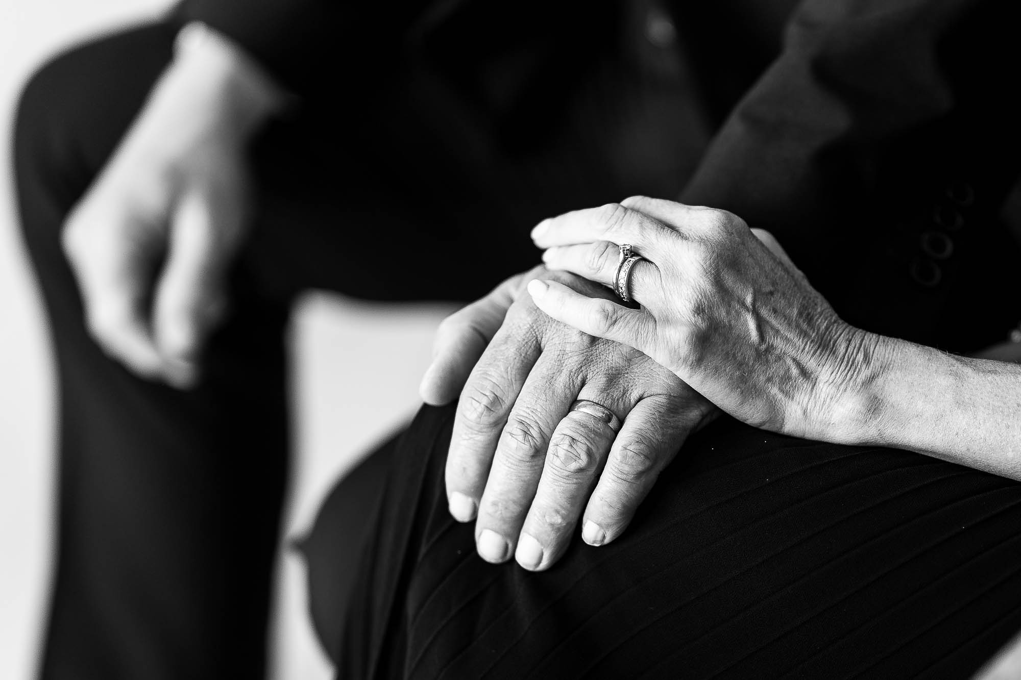 mother and father of the groom hold hands