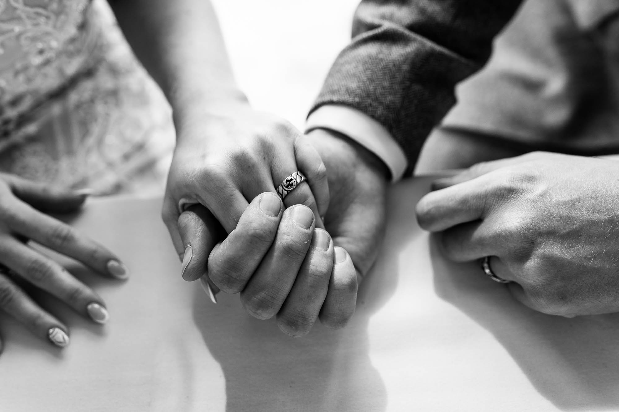 Bride and groom hold hands