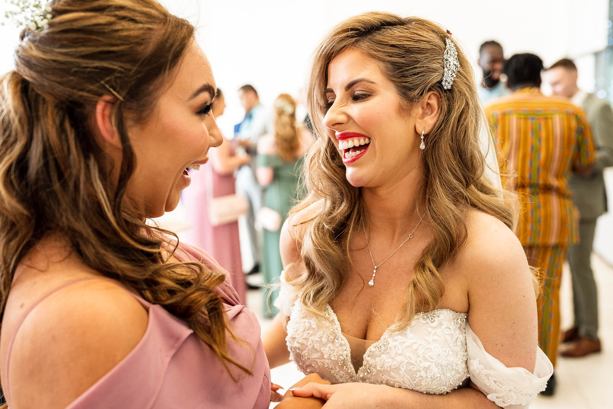 Bride shares a joke with bridesmaid