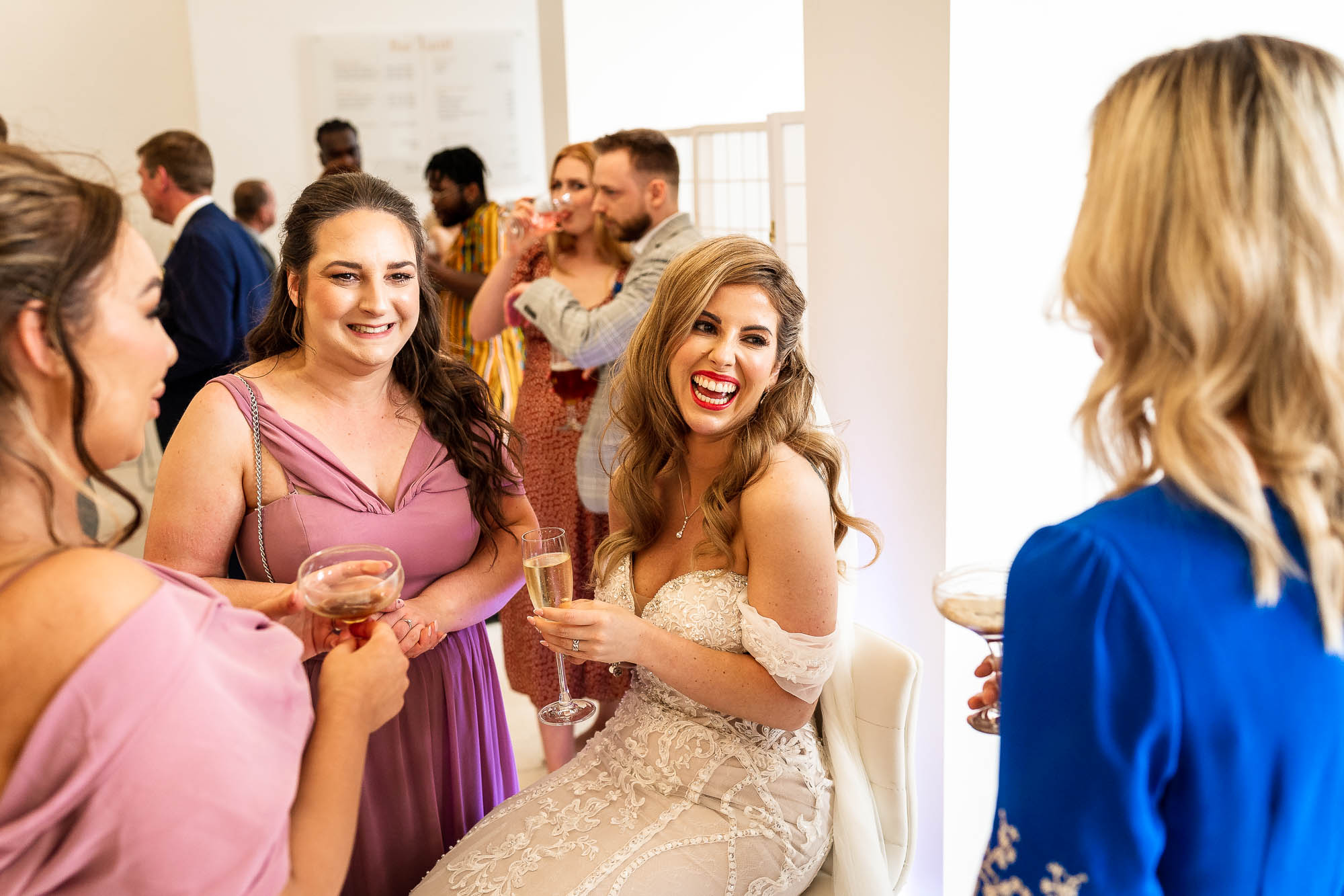 Bride shares a joke with wedding guests