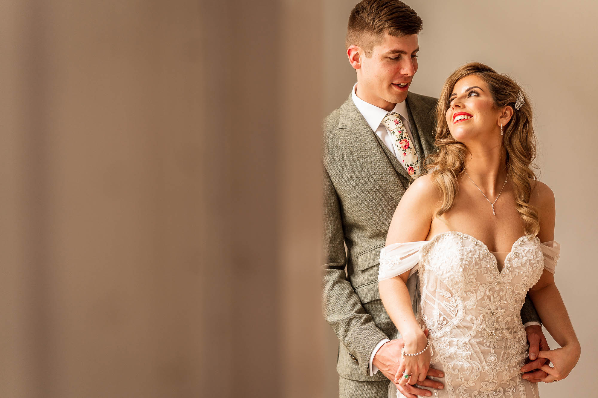 Bride and groom smile at each other