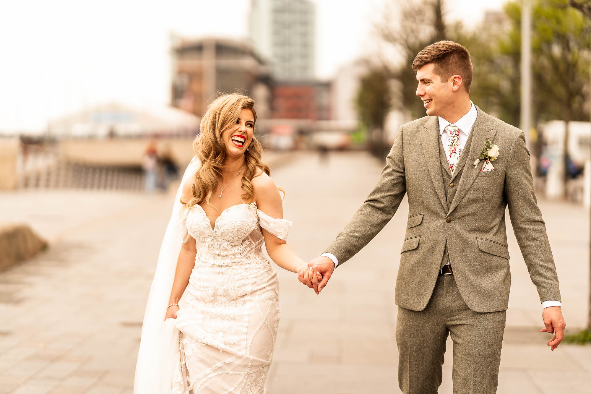 Bride and groom laughing as they walk