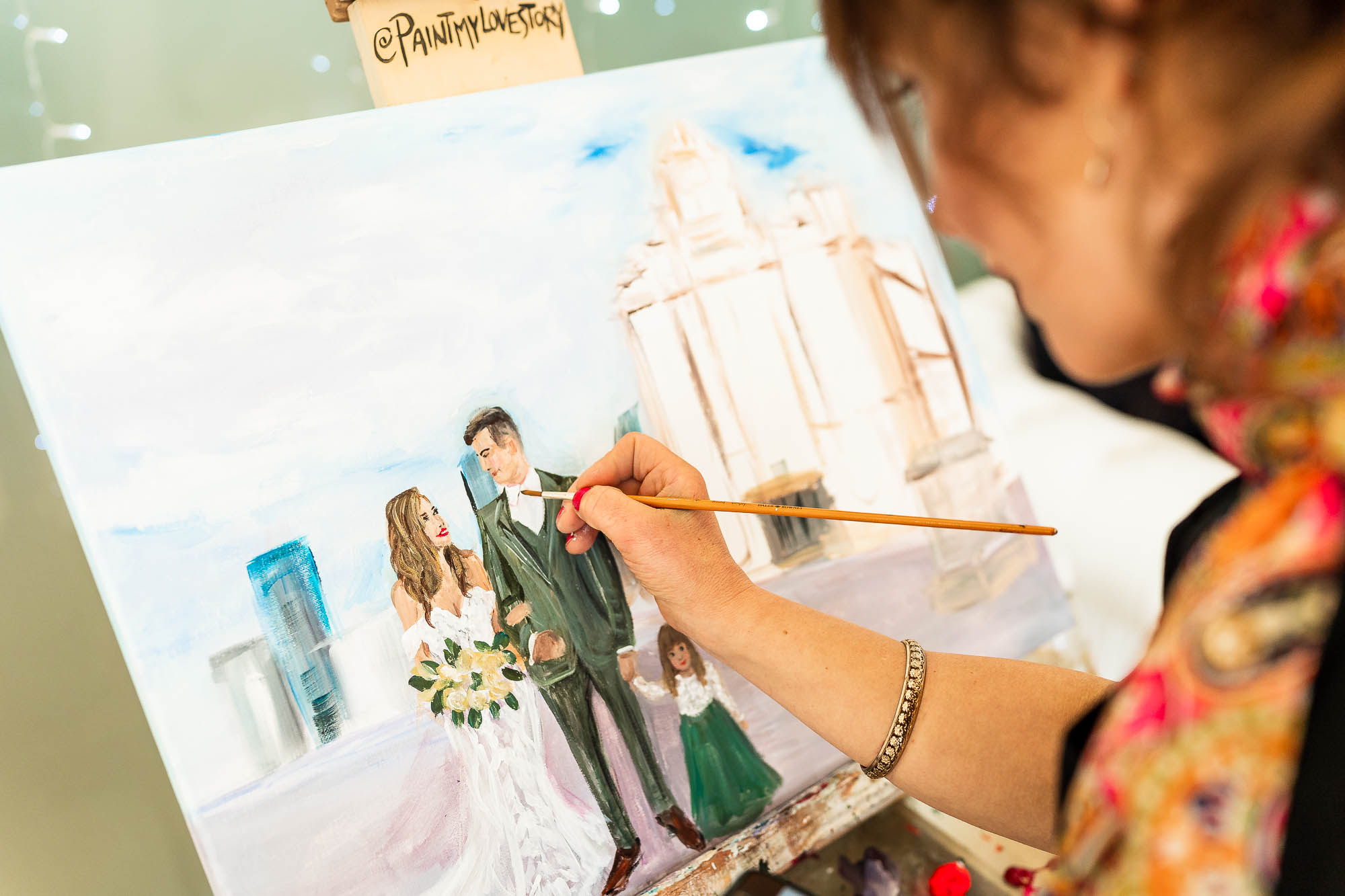 Artist paints the bride and groom