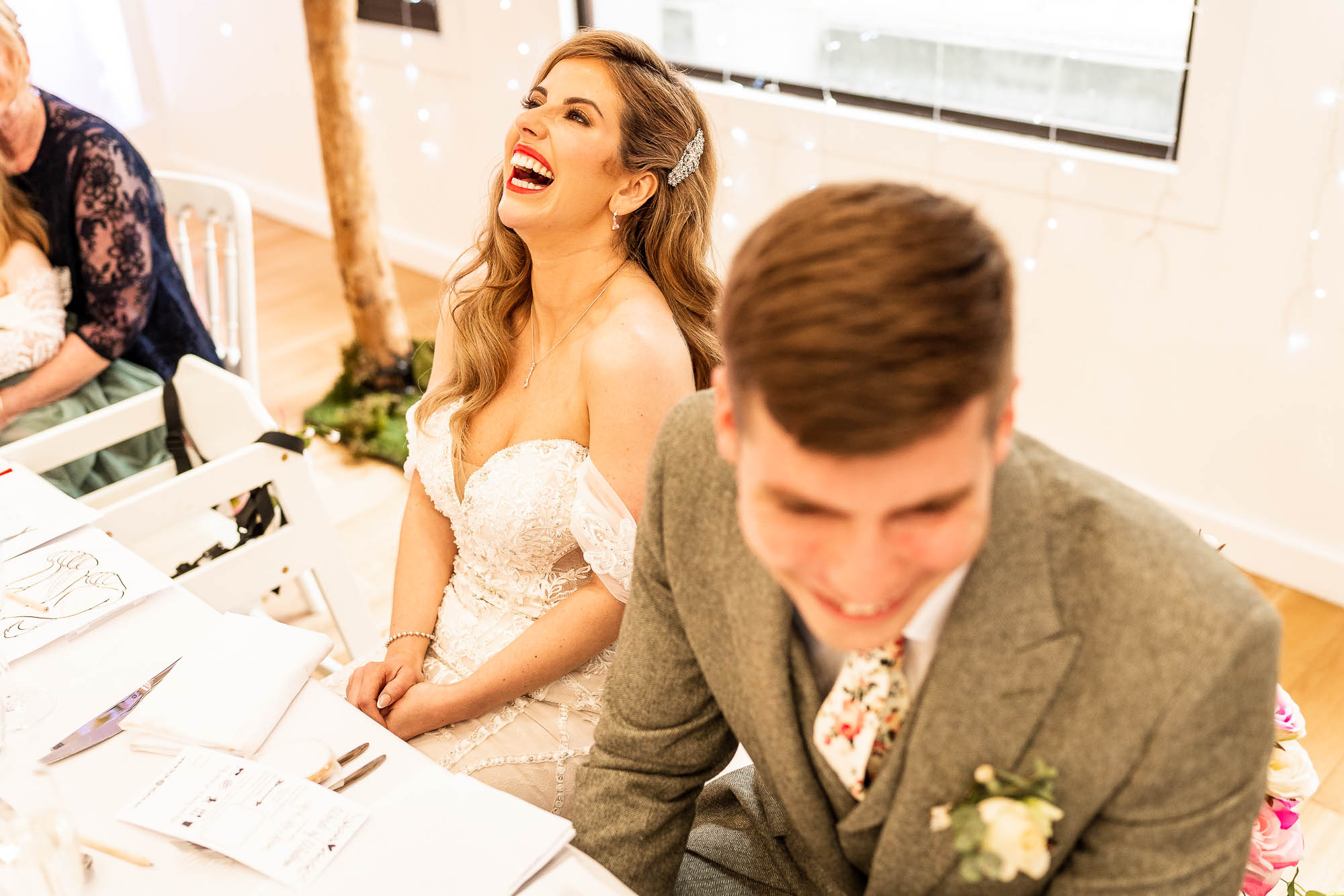 Bride laughs during best mans speech