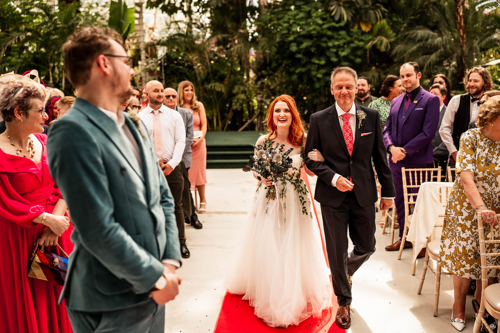 Bride walks up the aisle with the father of the bride