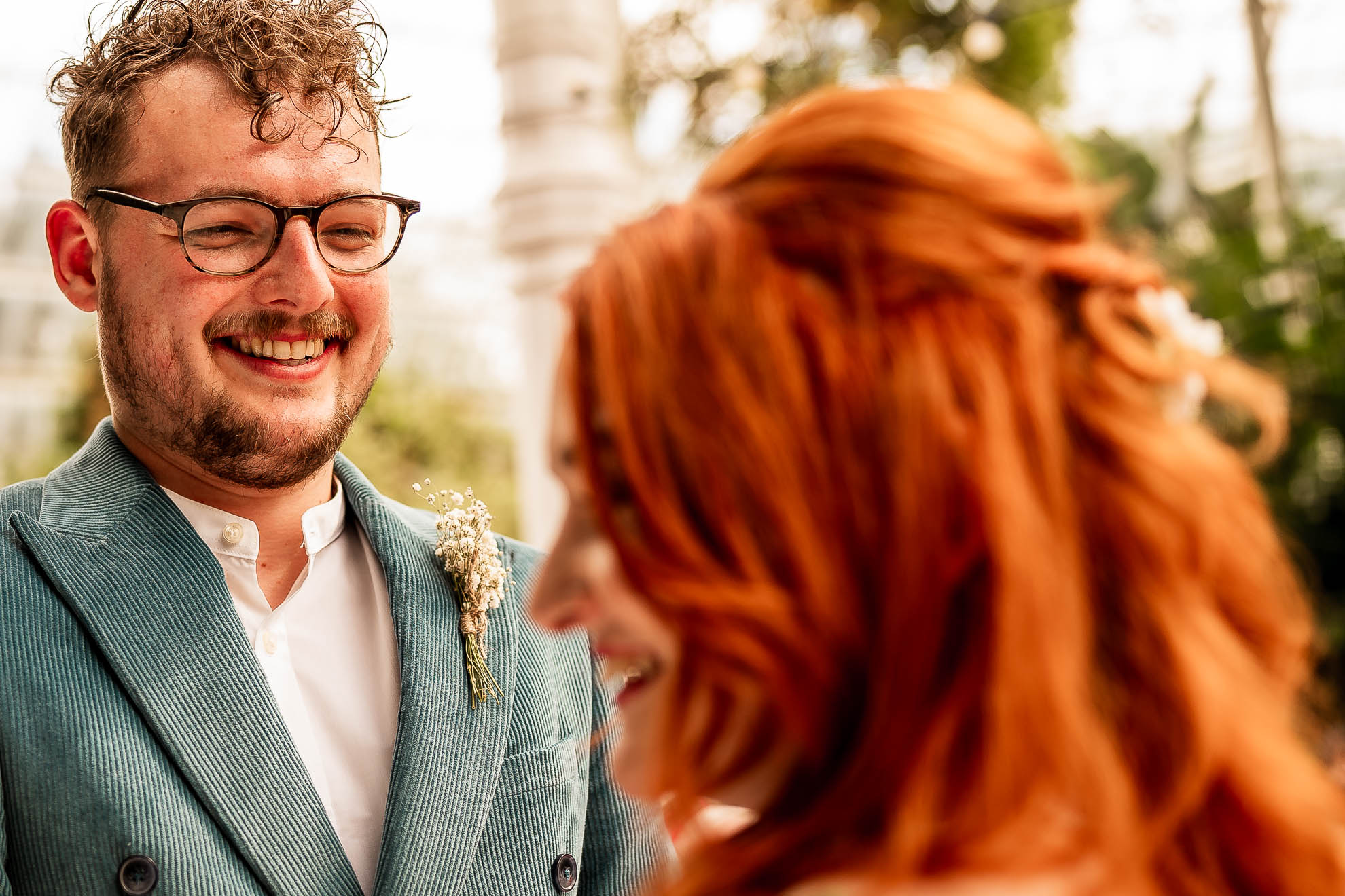 Groom smiles at the bride during the vows