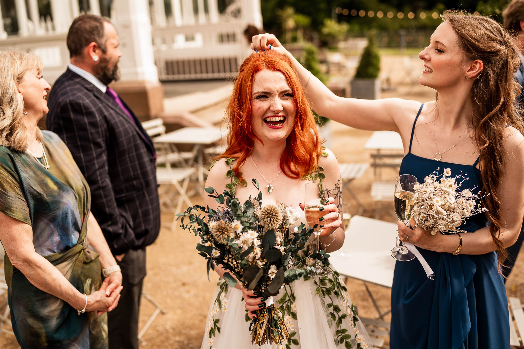 Bridesmaid picks confetti out of brides hair