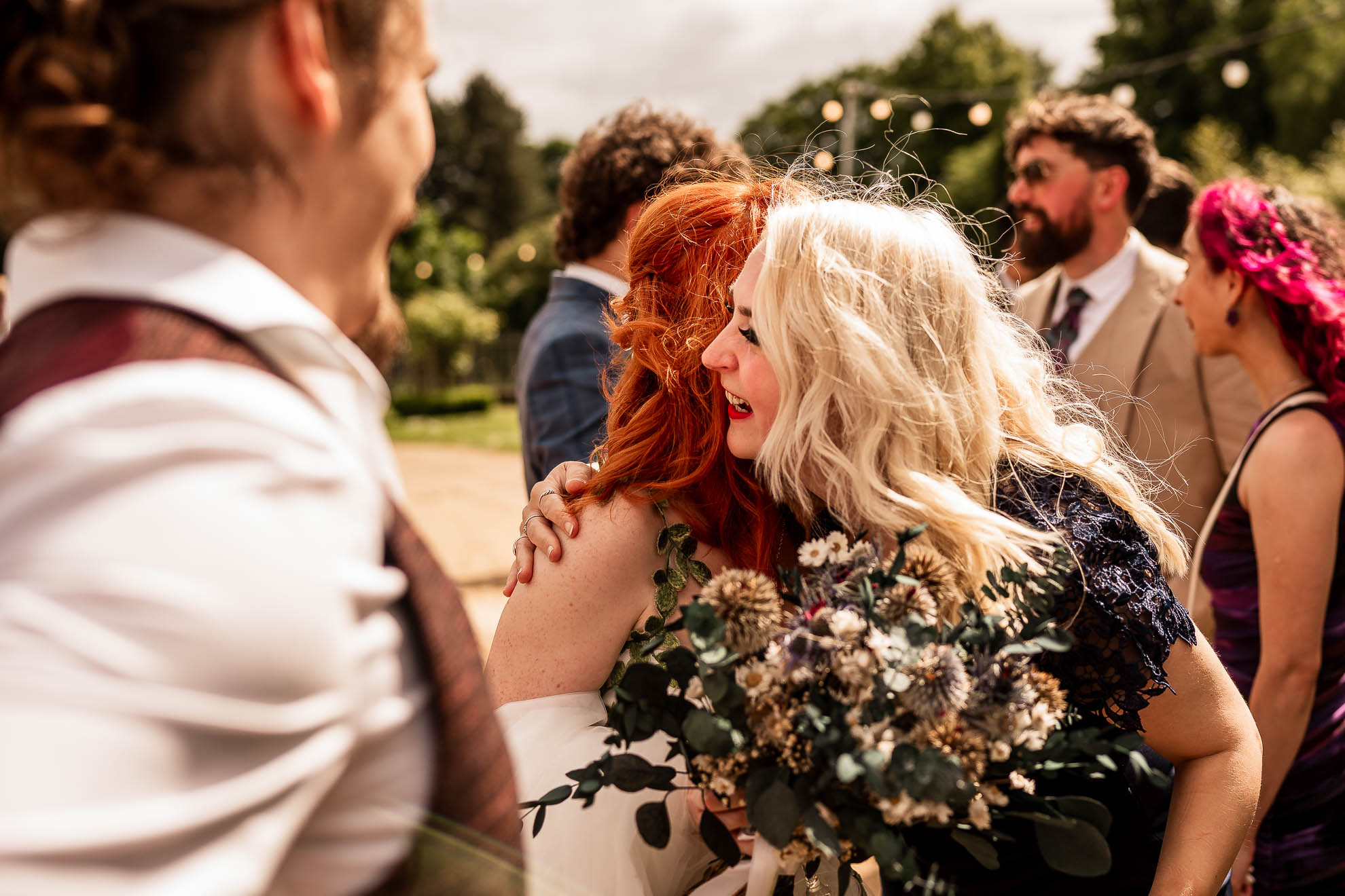 bridesmaid hugs bride