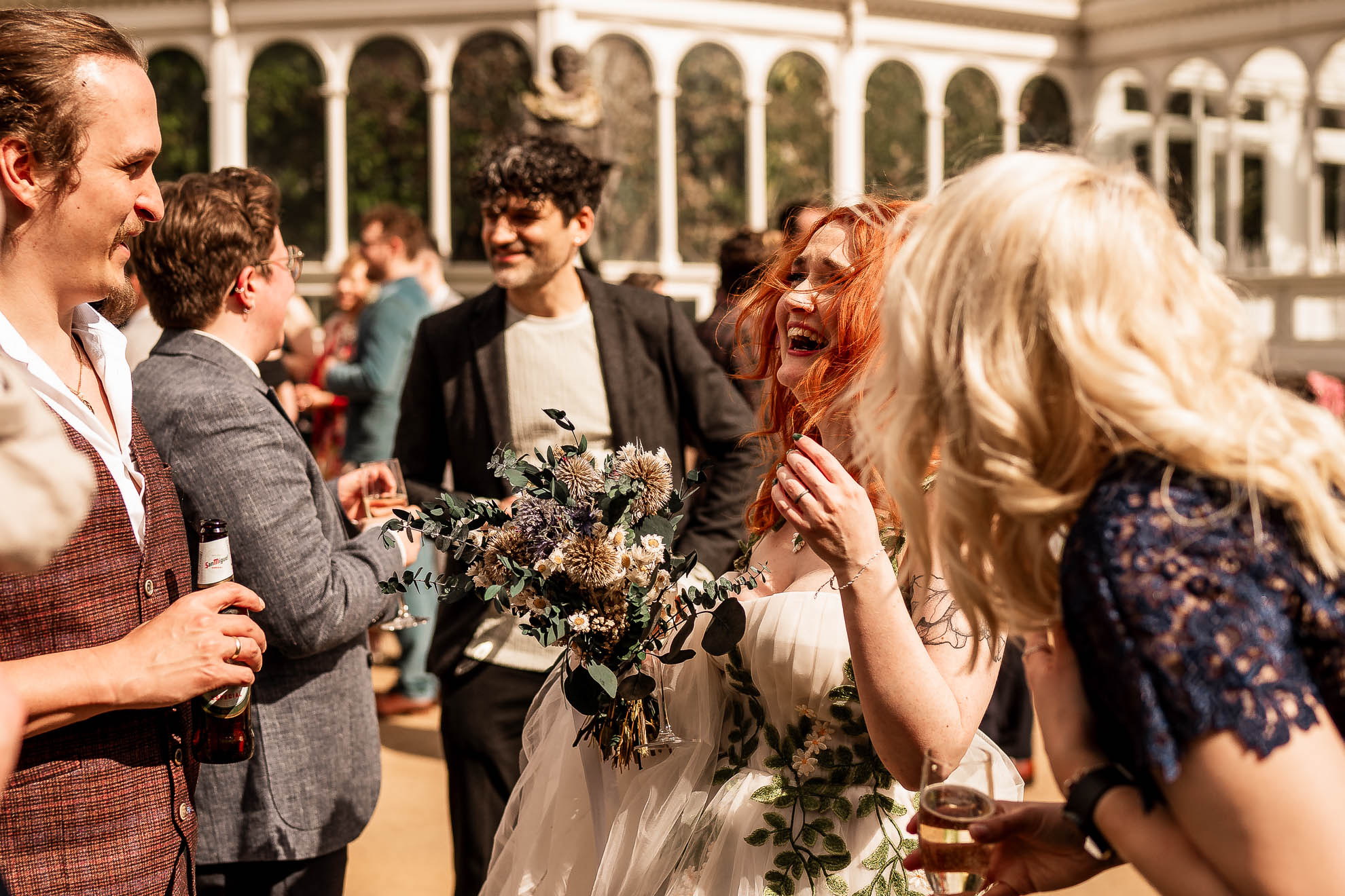 bride shares a joke with wedding guests