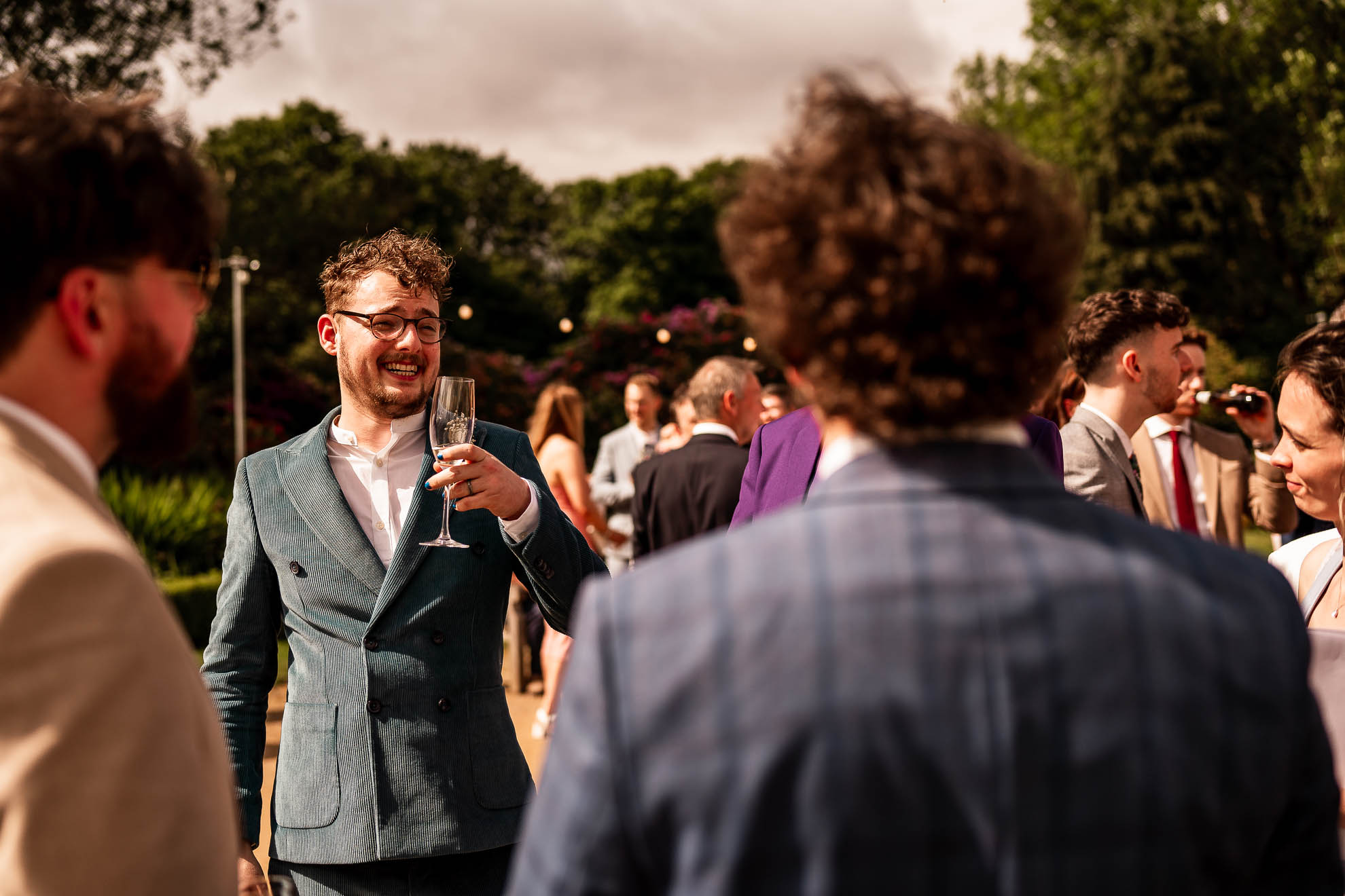 Groom enjoys some champagne during the drinks reception