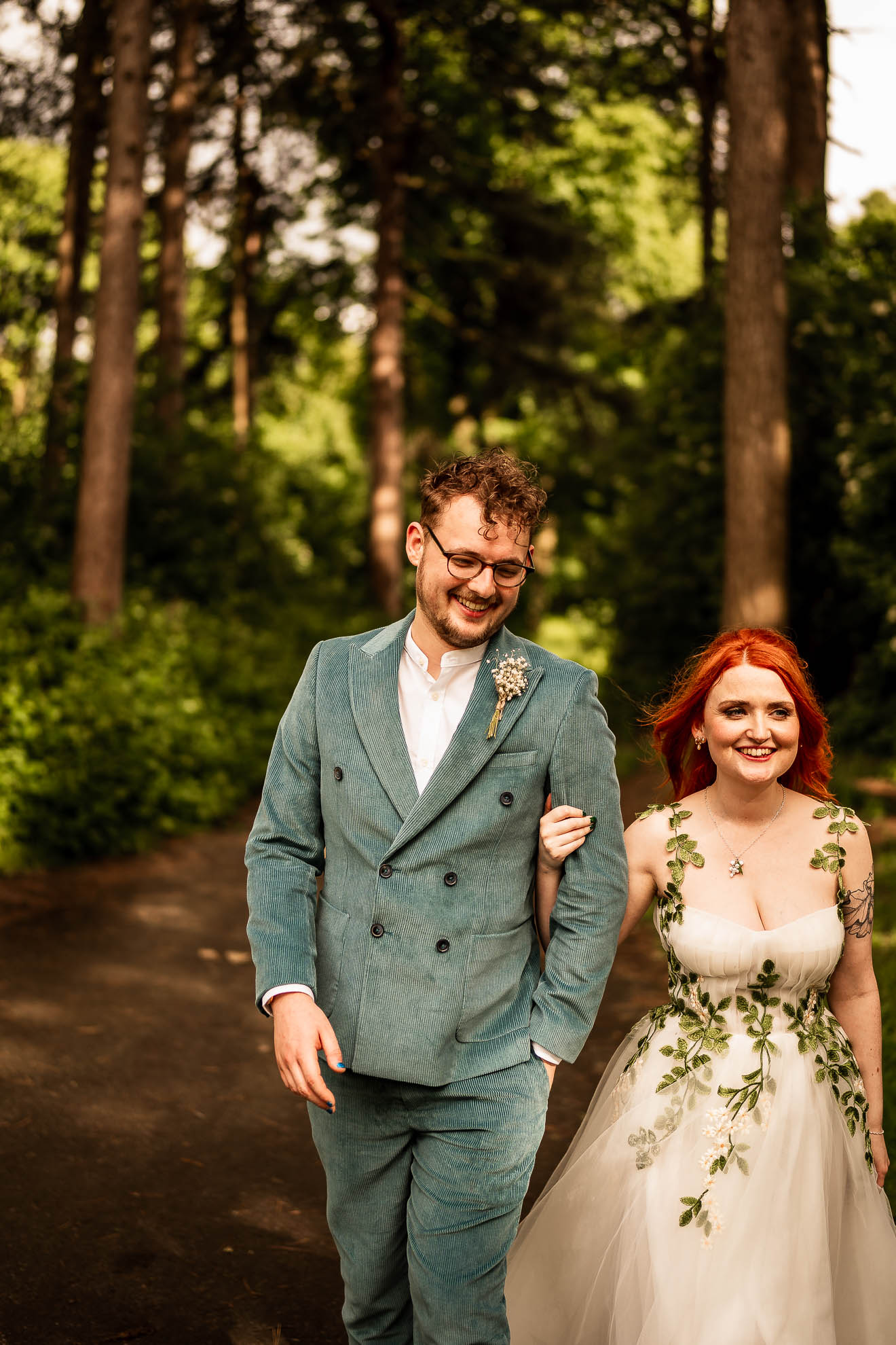 Bride and groom walk towards the palm house