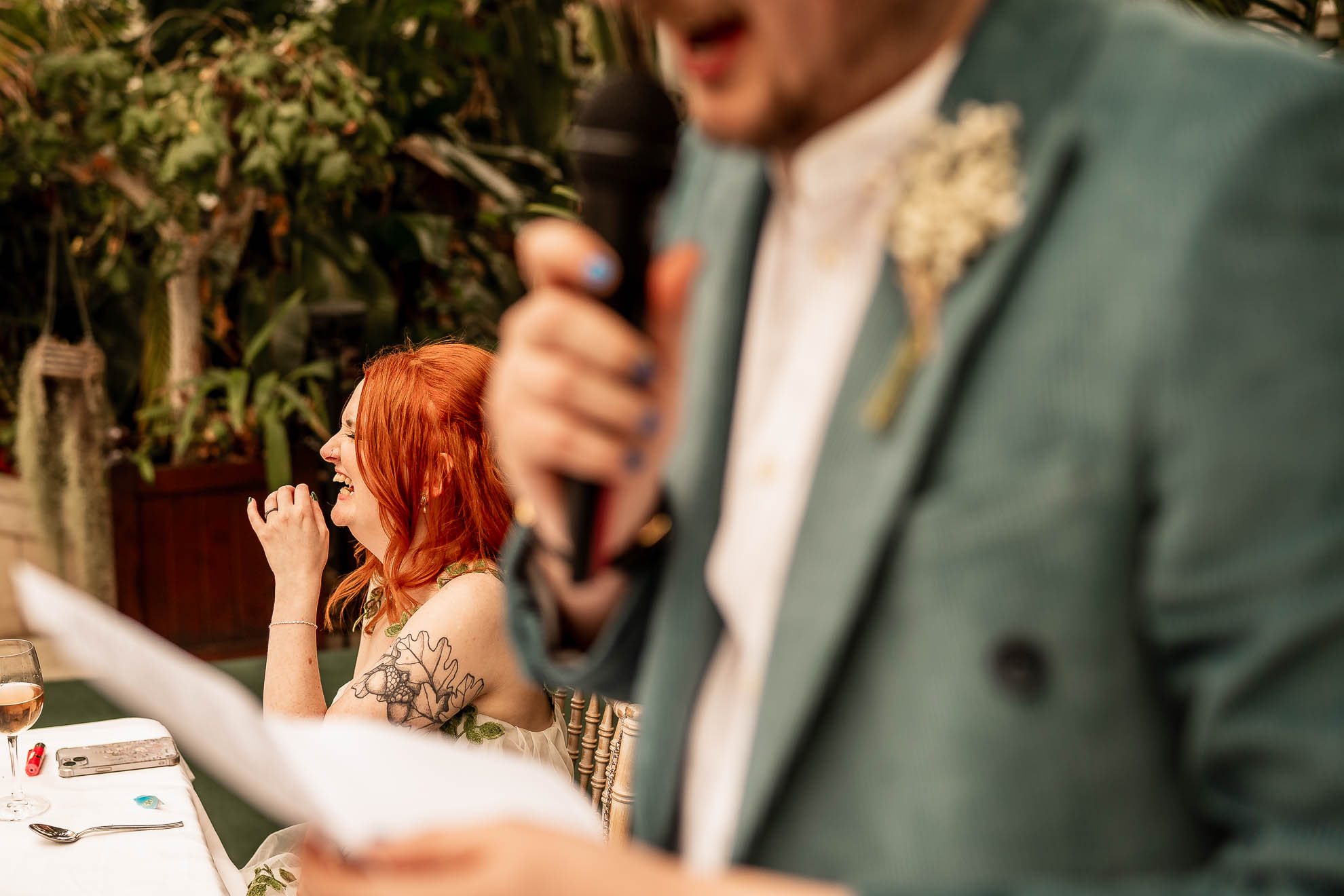 Bride laughing at grooms speech