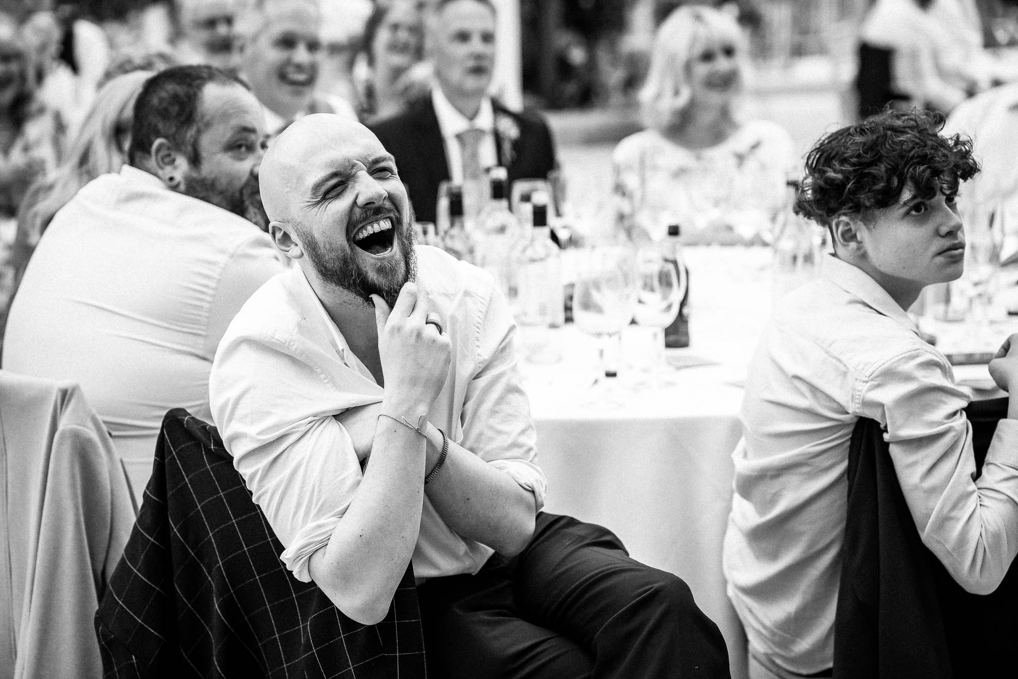 Wedding guest laughing during best mans speech