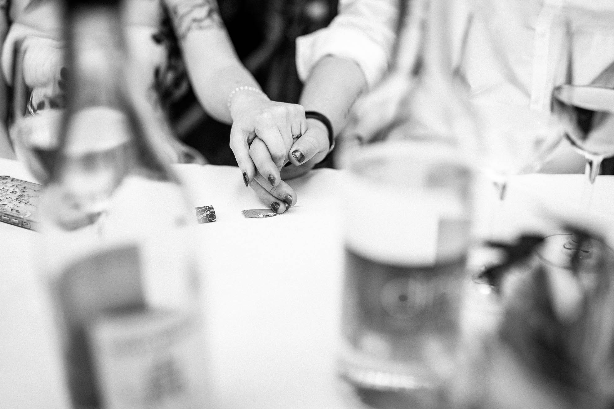 Bride and groom hold hands during the speeches