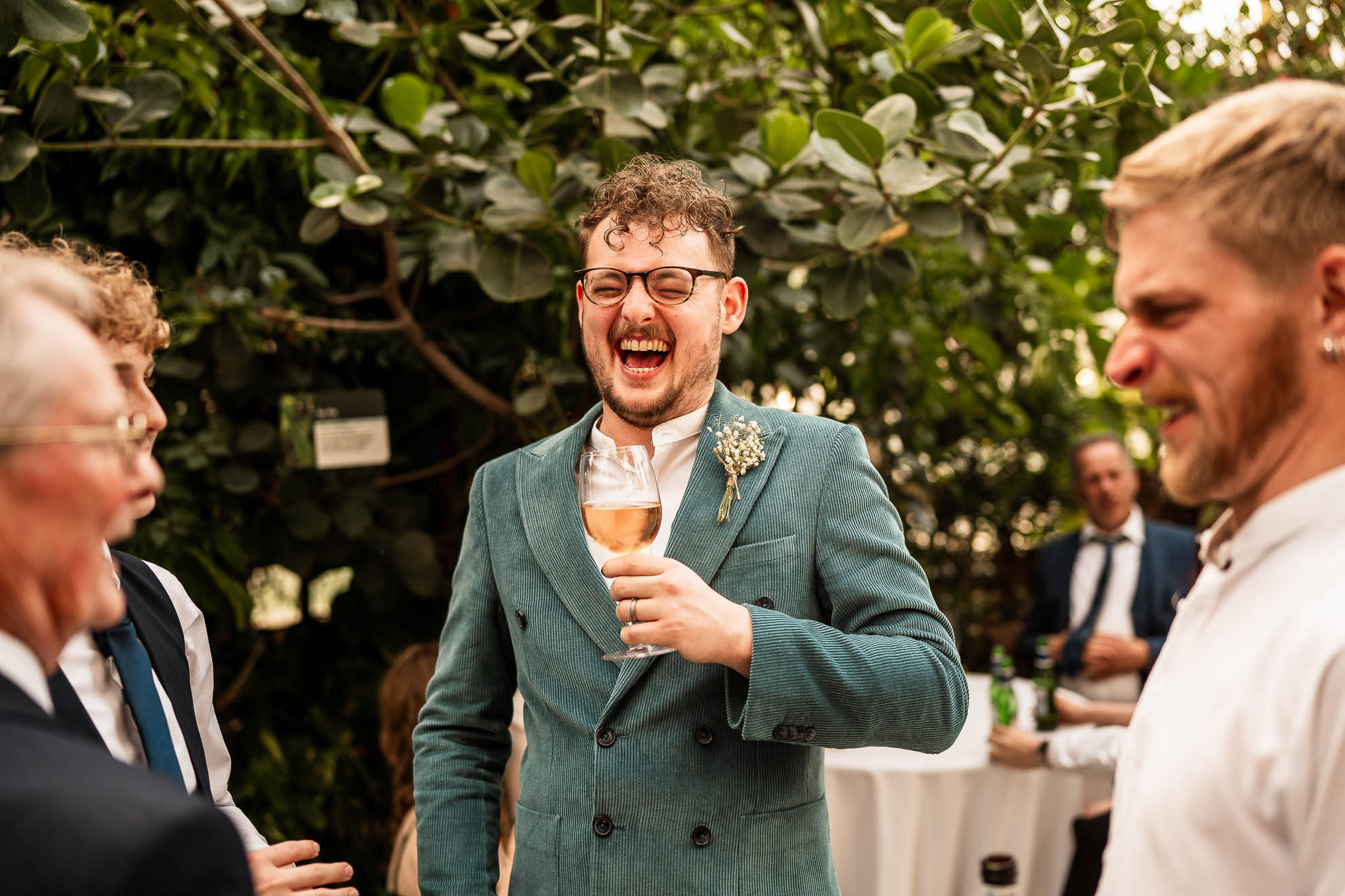 groom shares a joke with wedding guests