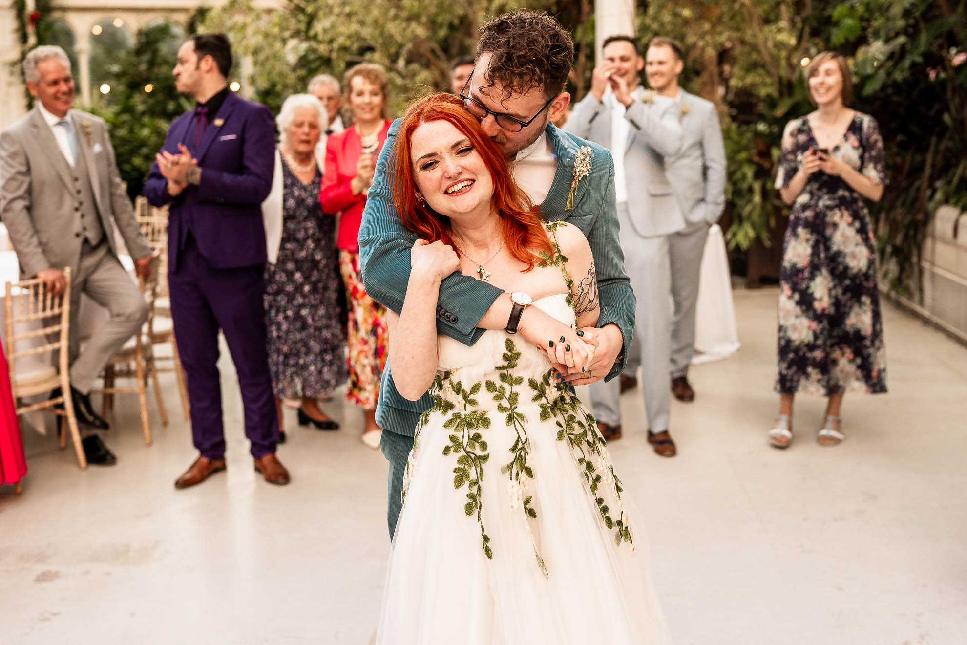 groom kisses bride during first dance