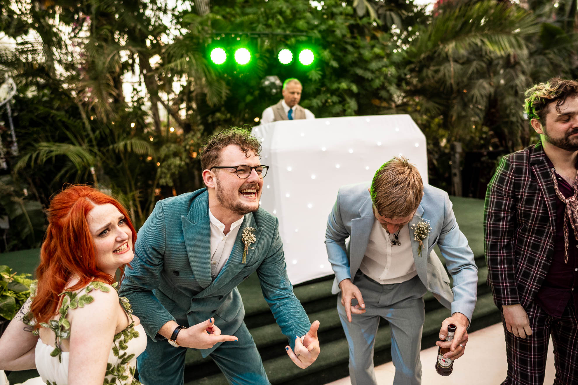 groomdoes air guitar with guests