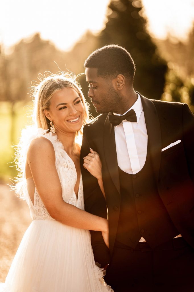 bride and groom hold each other close during the drinks reception