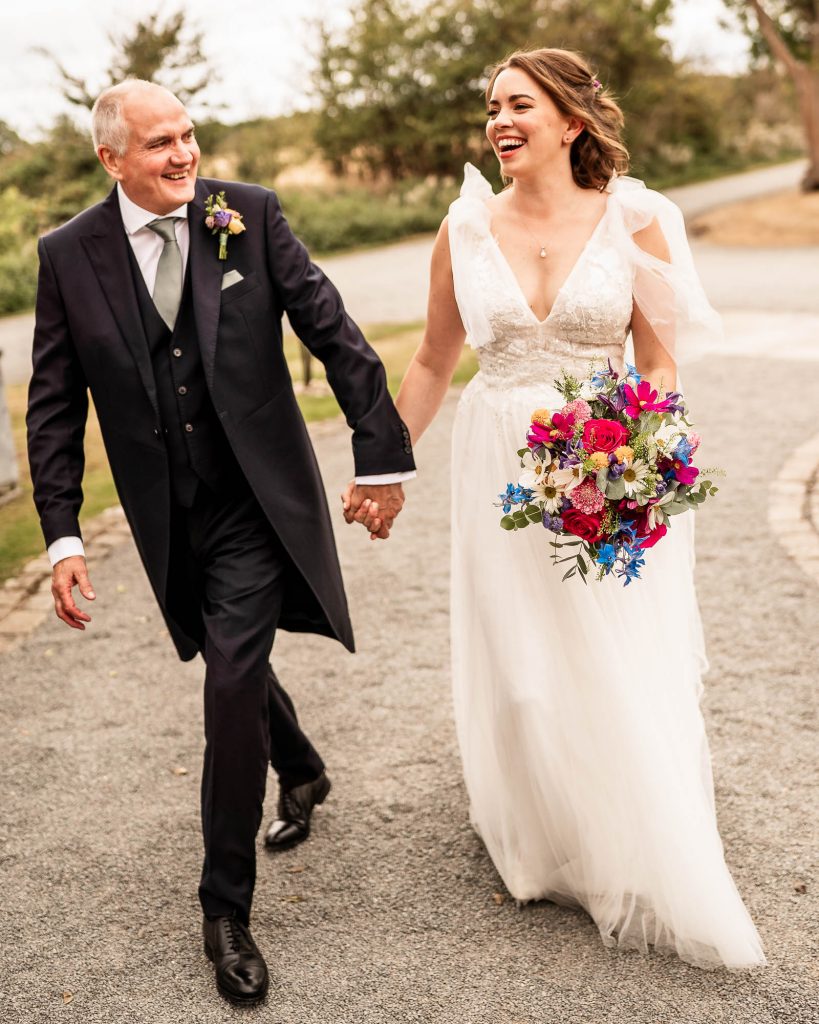 bride arrives at the church with father of the groom