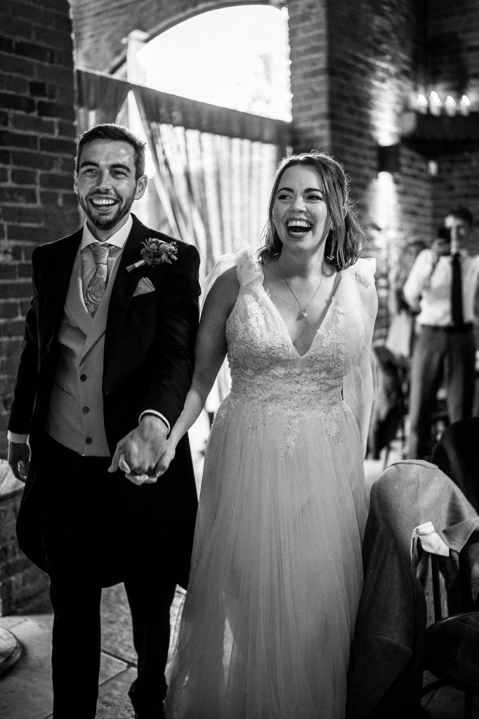 Bride and groom enter the wedding breakfast