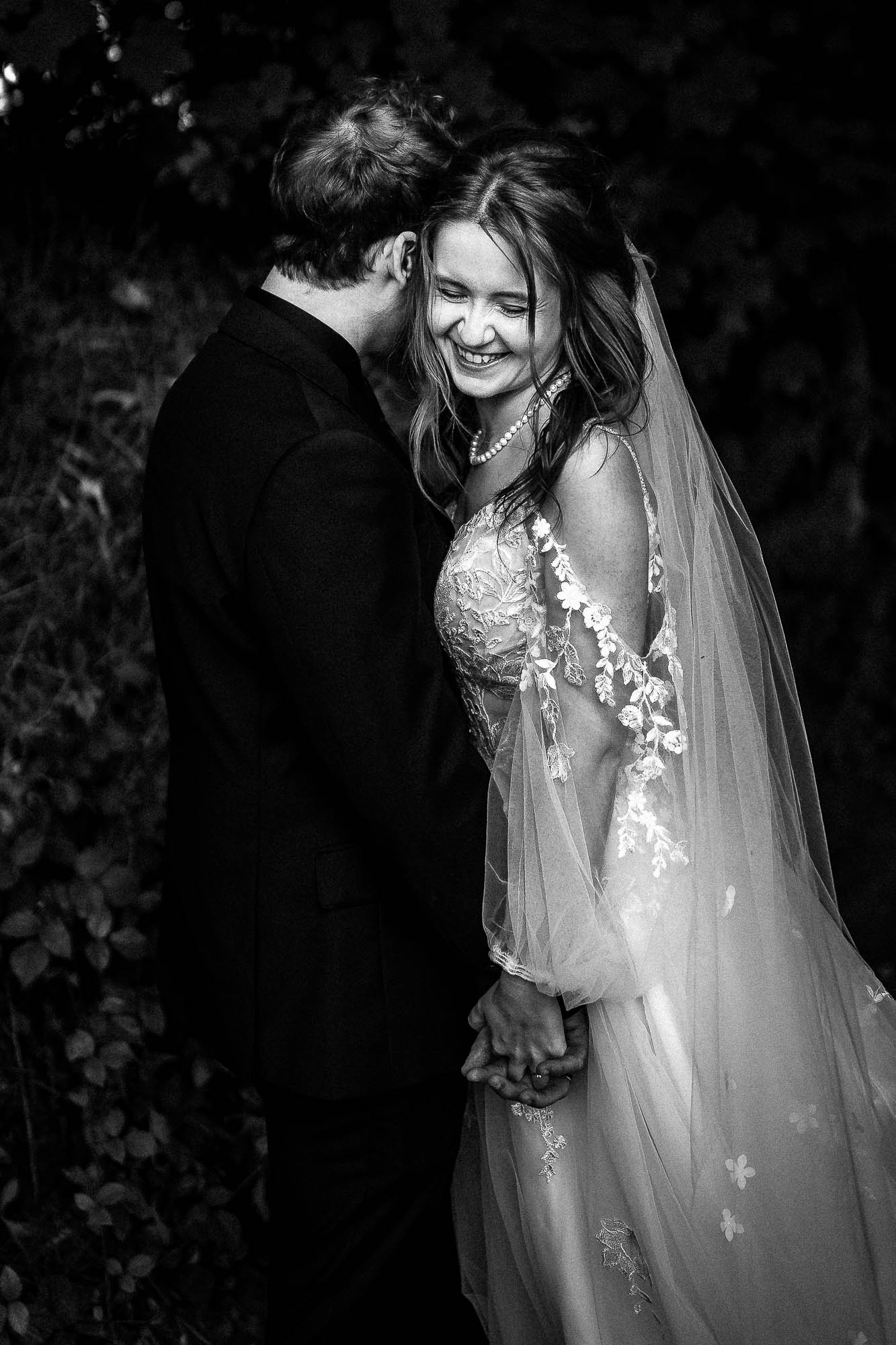 Bride and groom laughing together during natural wedding photography at Wonwood Barton