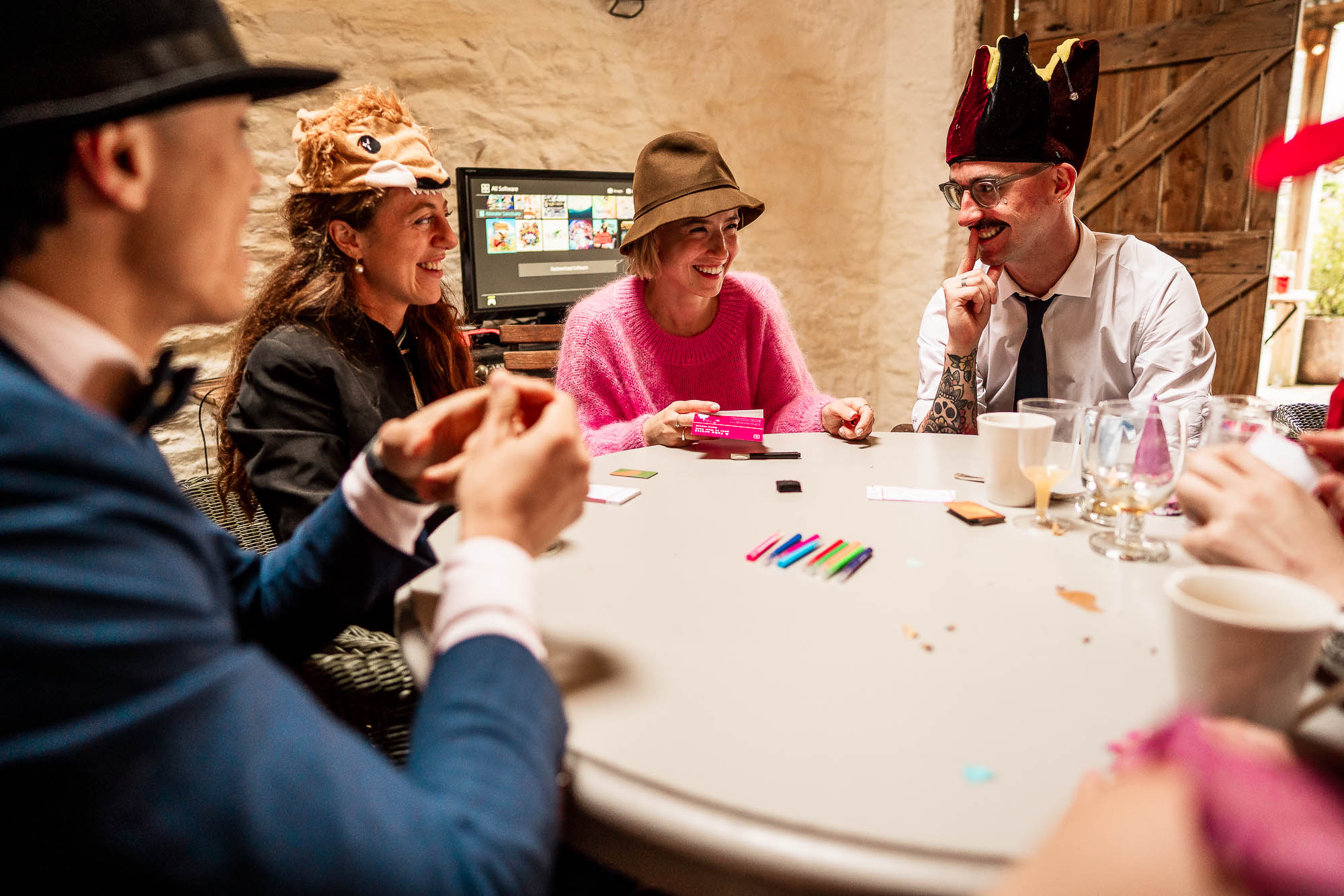 Wedding guests playing table games during evening reception at Wonwood Barton in Devon