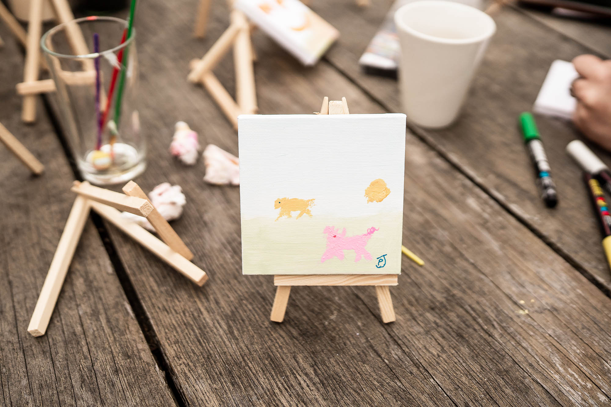 Mini canvas painting activity during creative wedding reception at Wonwood Barton