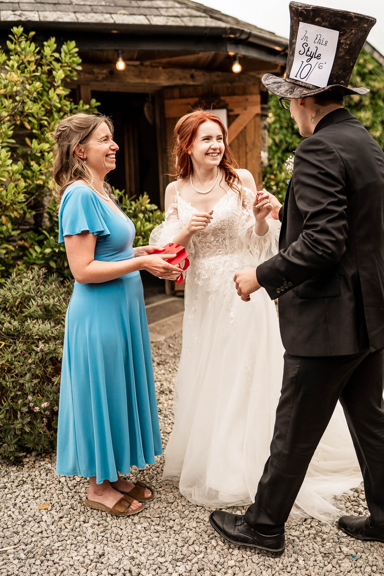 Bride laughing with guest during drinks reception at Wonwood Barton wedding