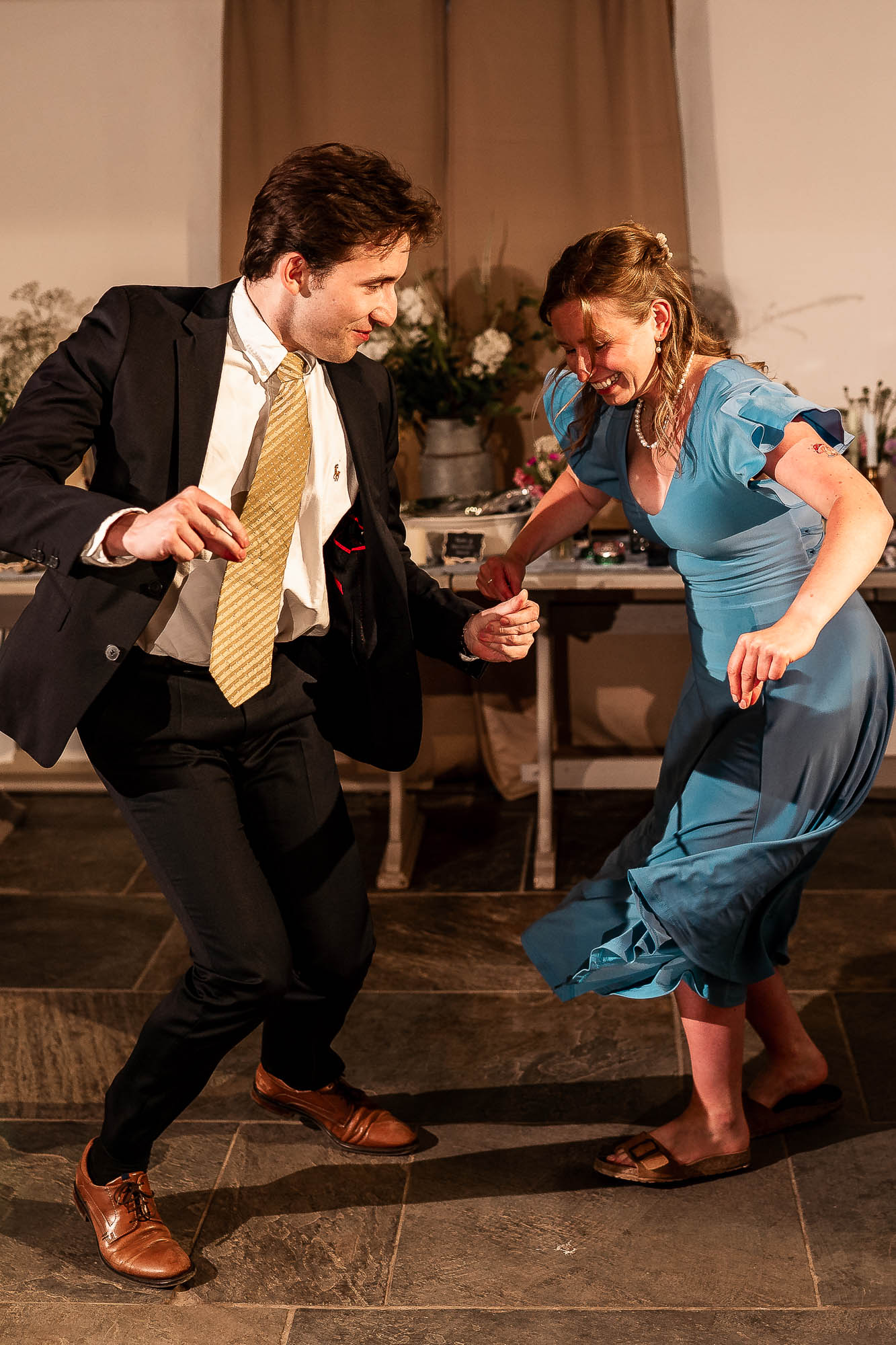 Couple dancing together during evening reception at rustic Devon wedding venue