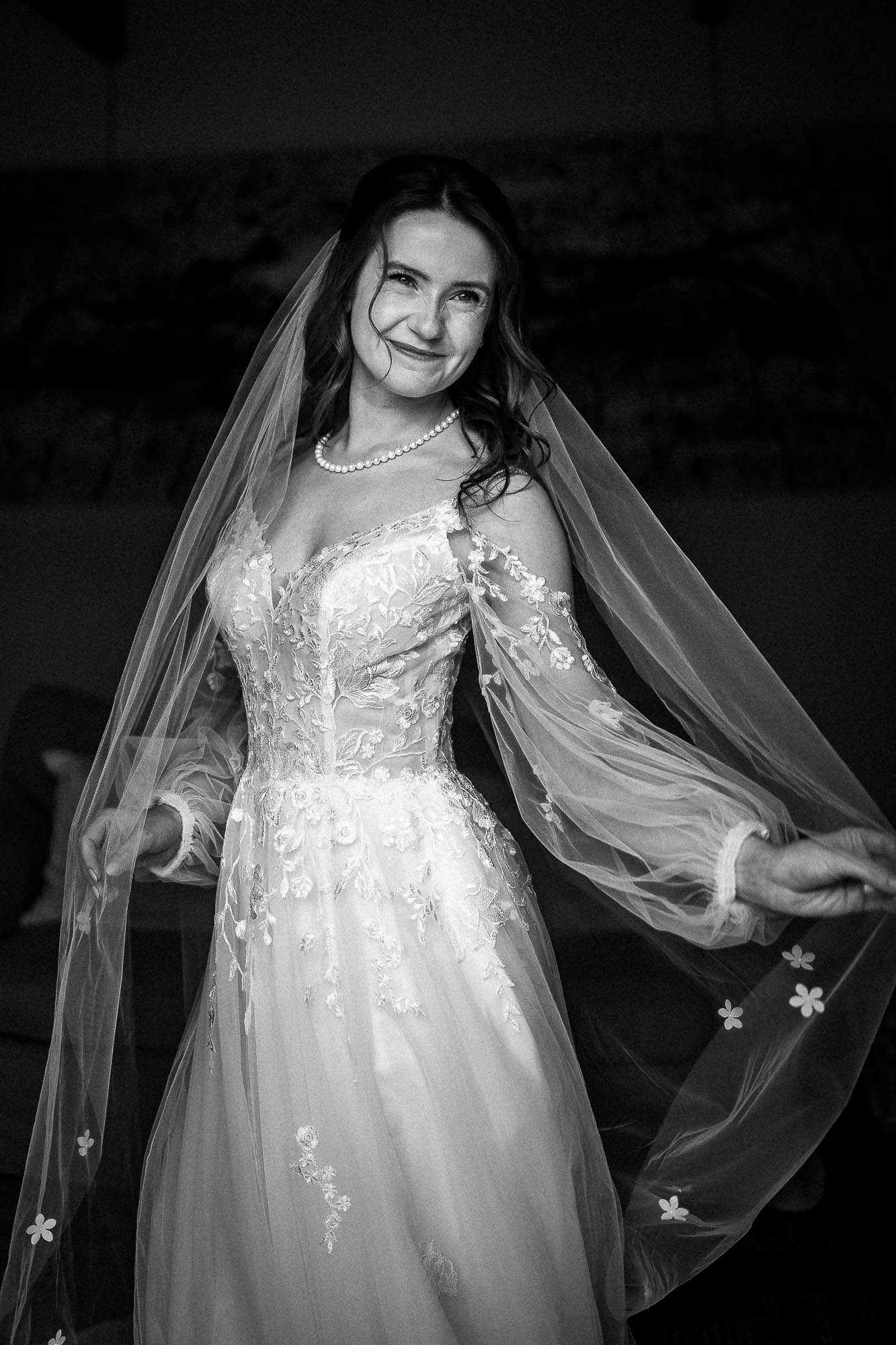 Bride holding veil outstretched in elegant bridal portrait at Wonwood Barton