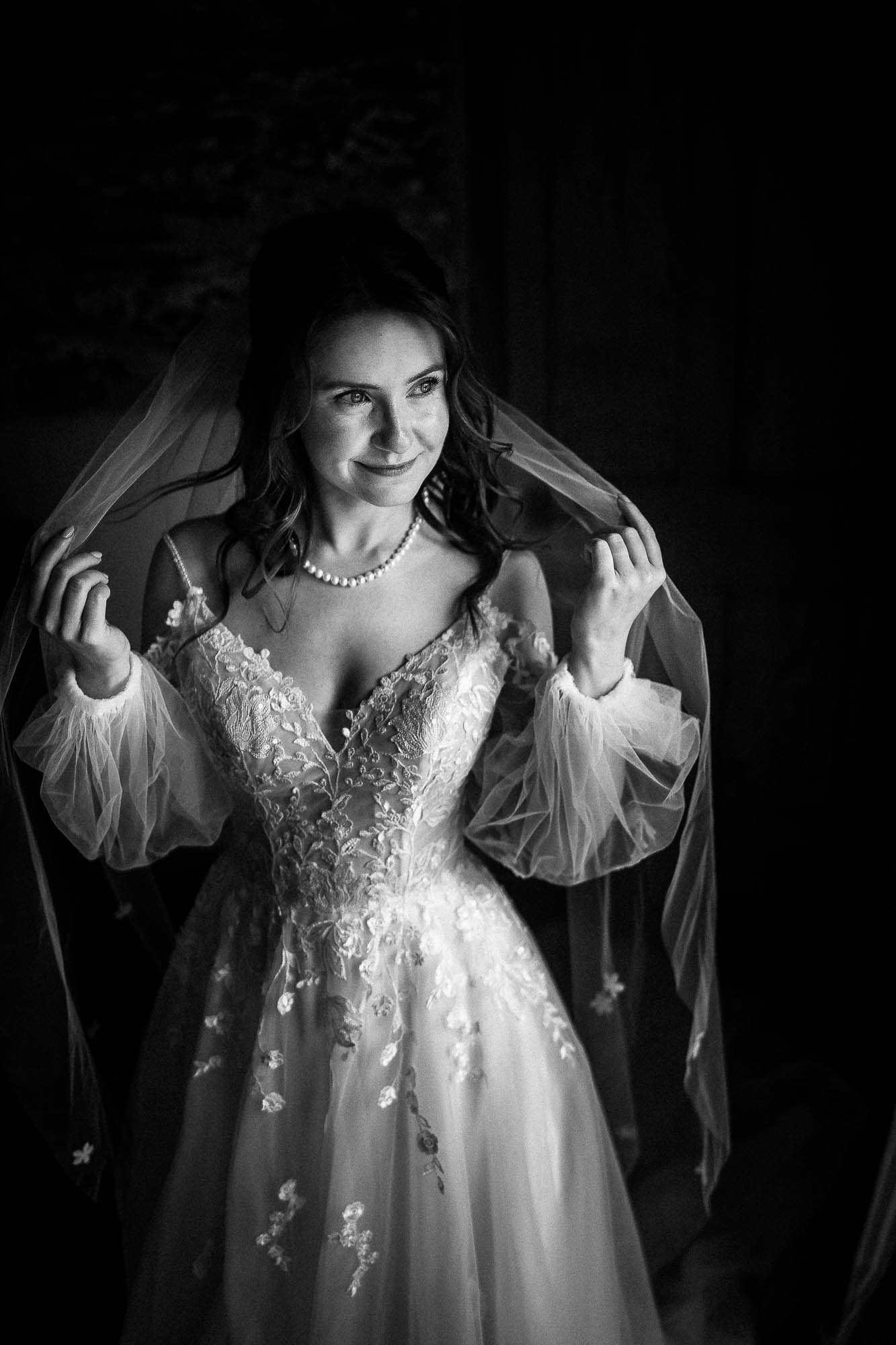 Bride adjusting veil in natural light during documentary style bridal prep at Wonwood Barton