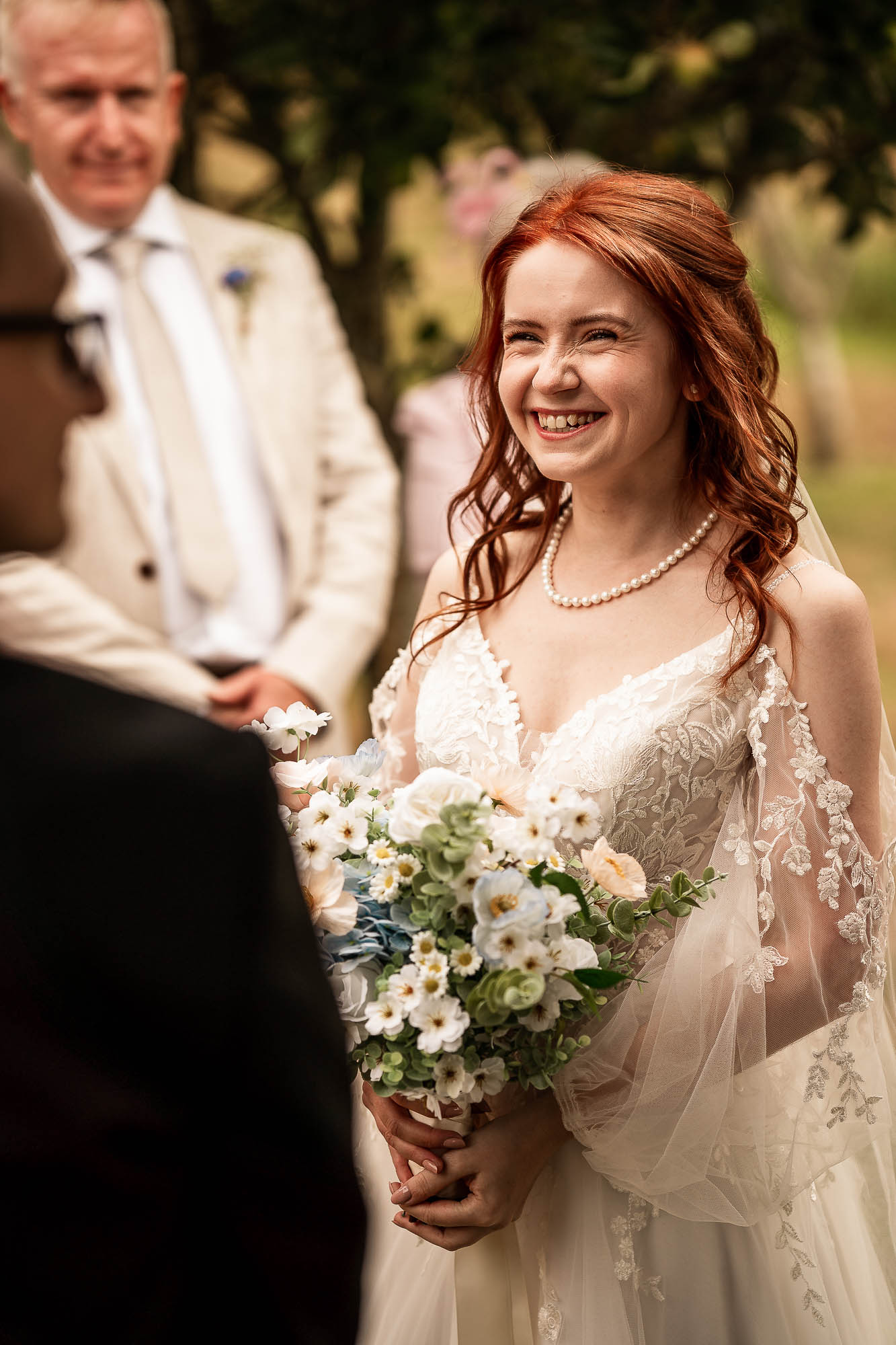 Close up of bride smiling during vows at Wonwood Barton wedding ceremony