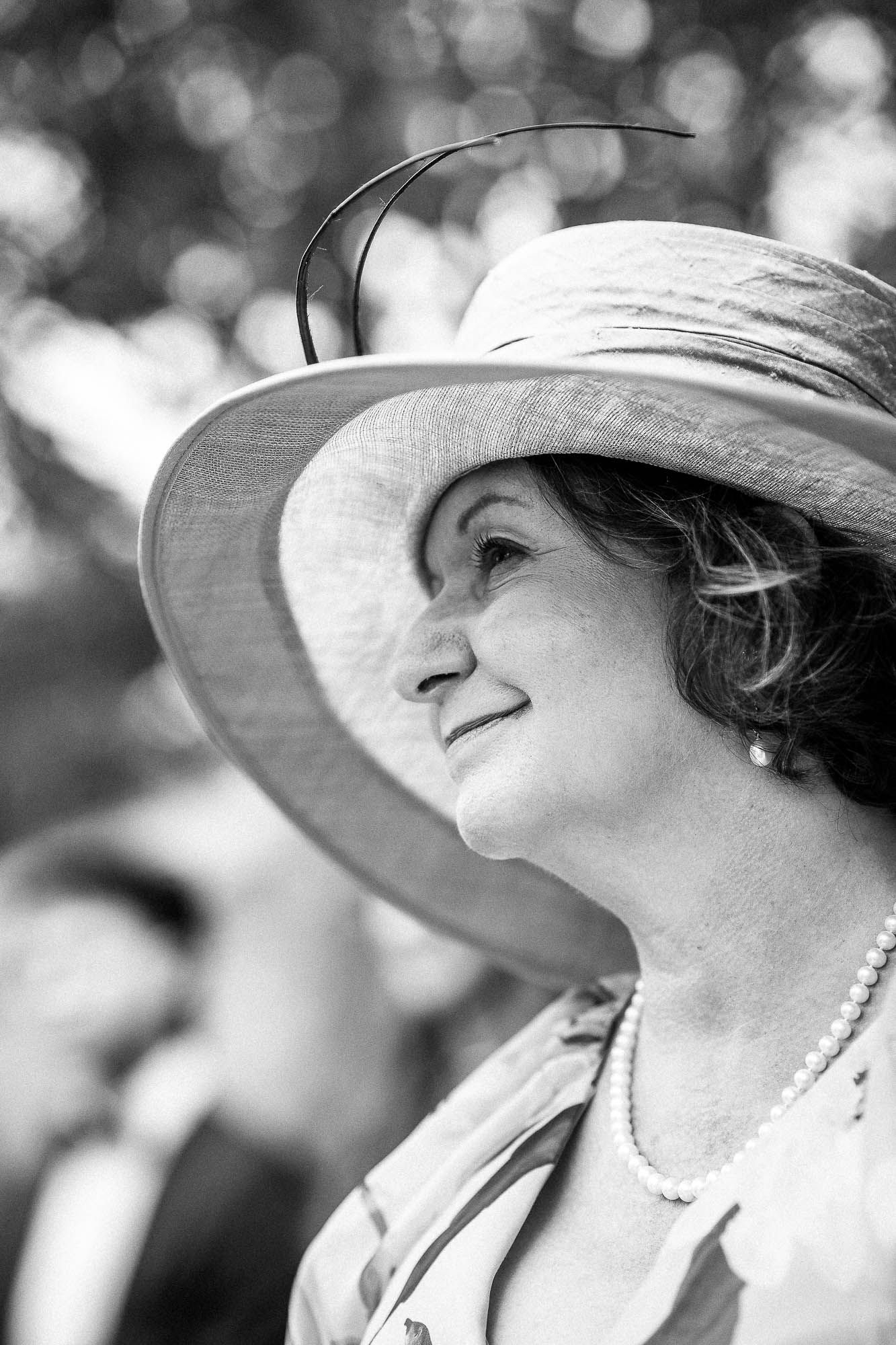 Black and white portrait of mother of the bride in pink hat at Wonwood Barton