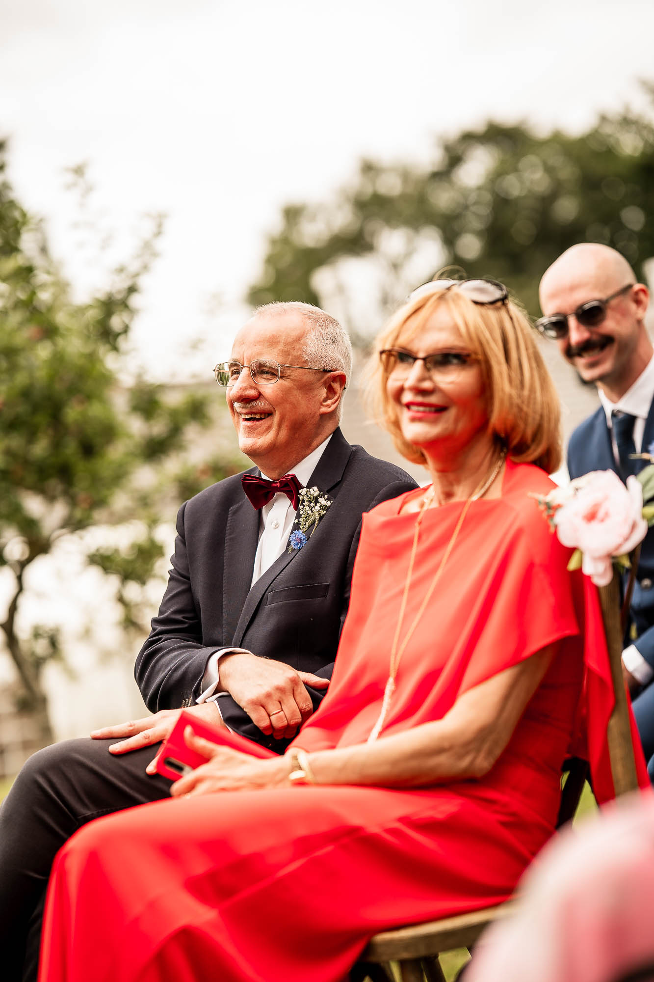 Mother and father of the groom smiling during countryside wedding ceremony at Wonwood Barton