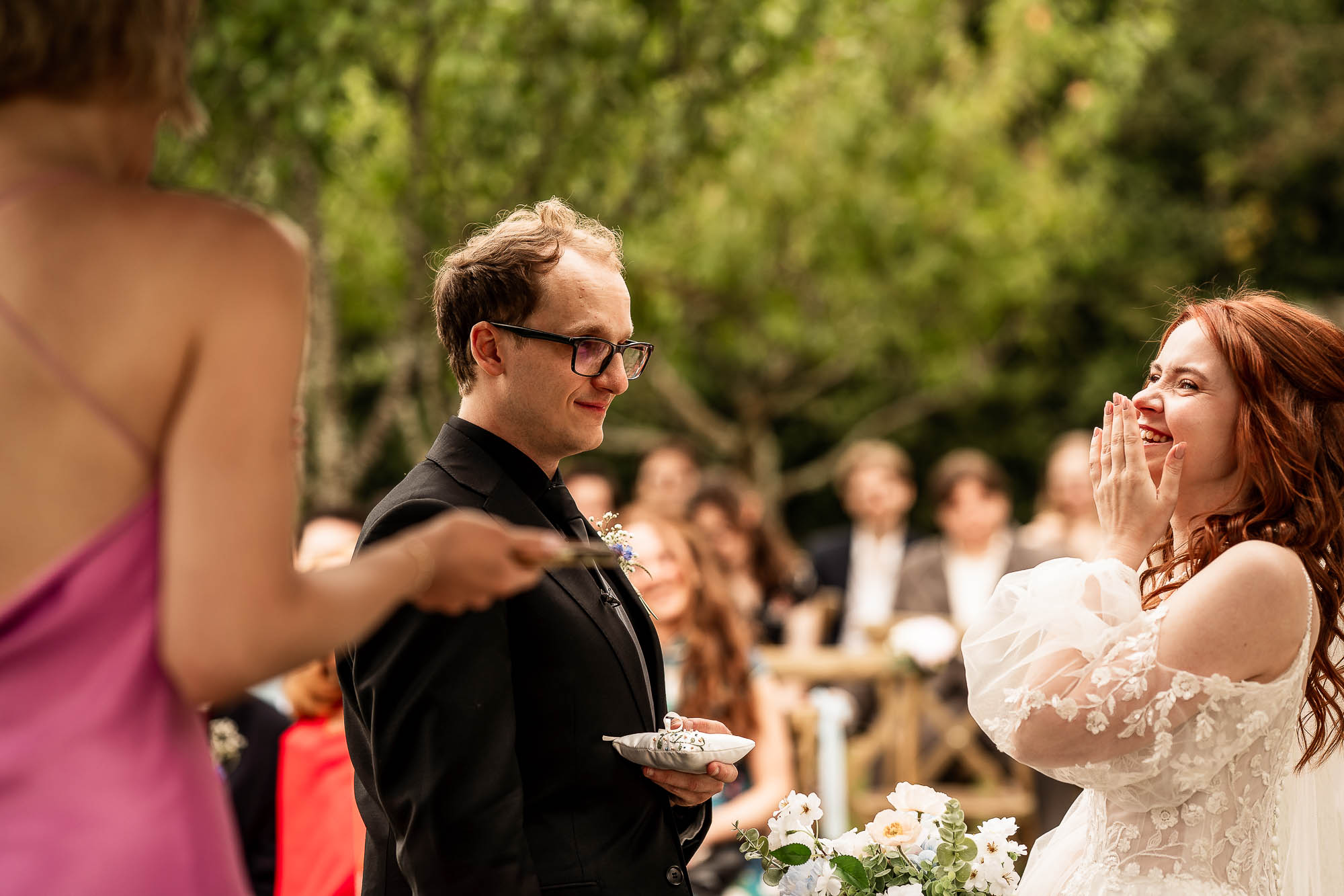 Bride laughing during ring exchange at Wonwood Barton outdoor wedding ceremony