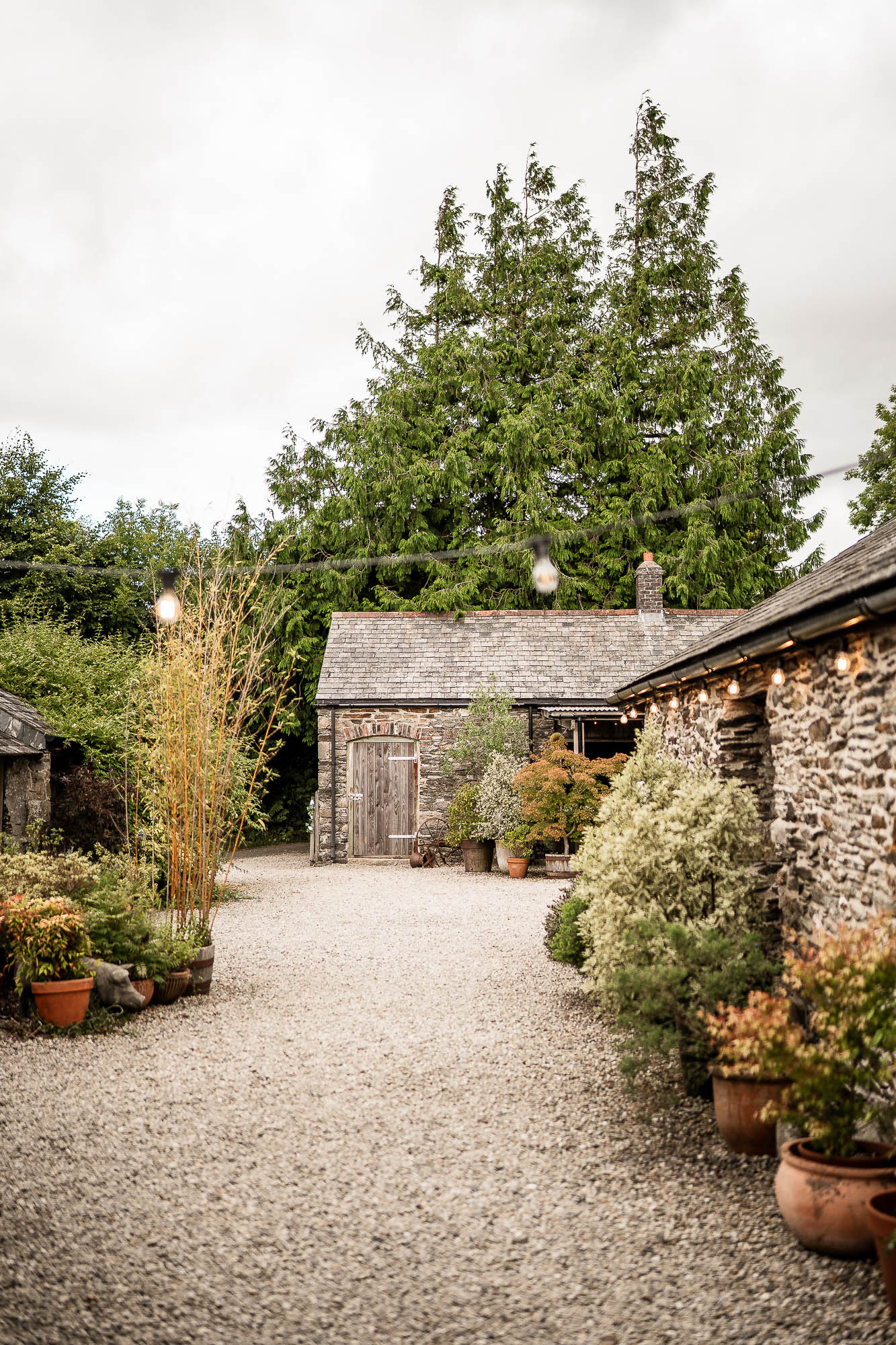 Gravel courtyard and stone barns at Wonwood Barton Devon wedding venue