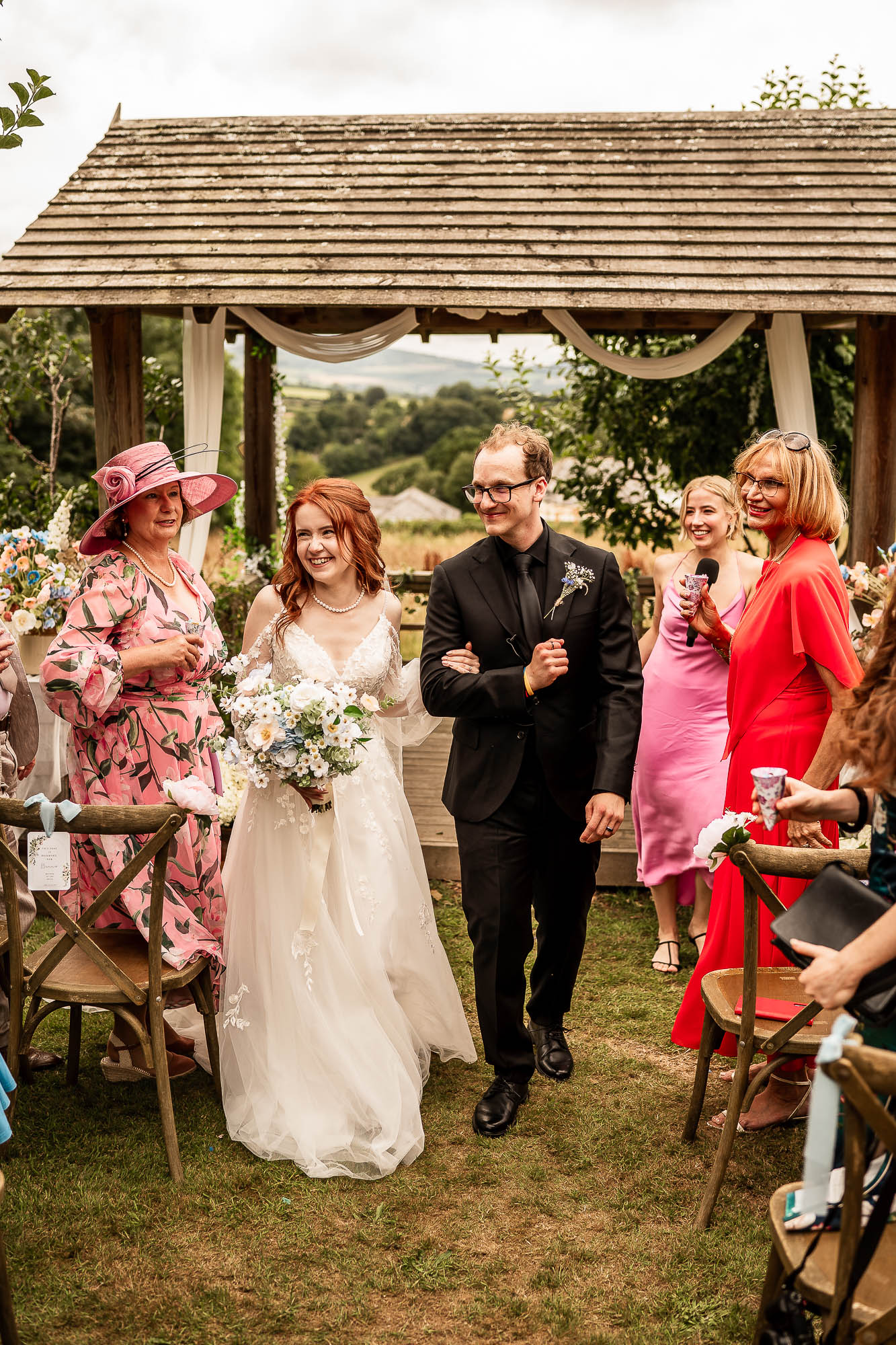 Bride and groom walking down aisle at Wonwood Barton after ceremony