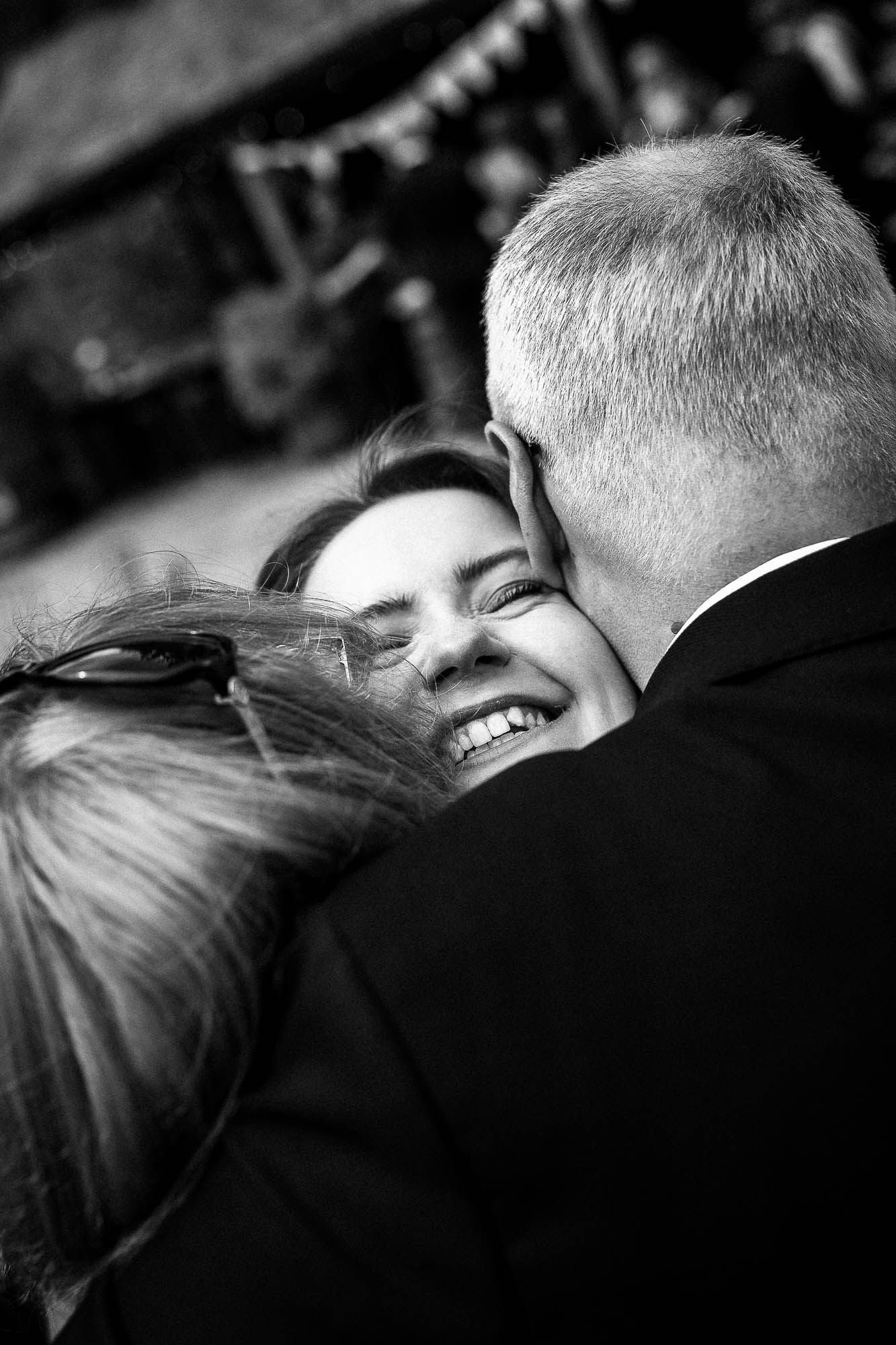 mother and father of the groom hug the bride at drinks reception at Wonwood Barton