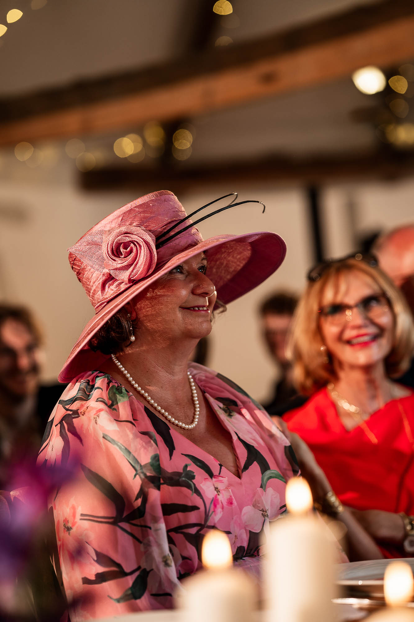 Mother of the bride listening to speeches during wedding breakfast at Wonwood Barton