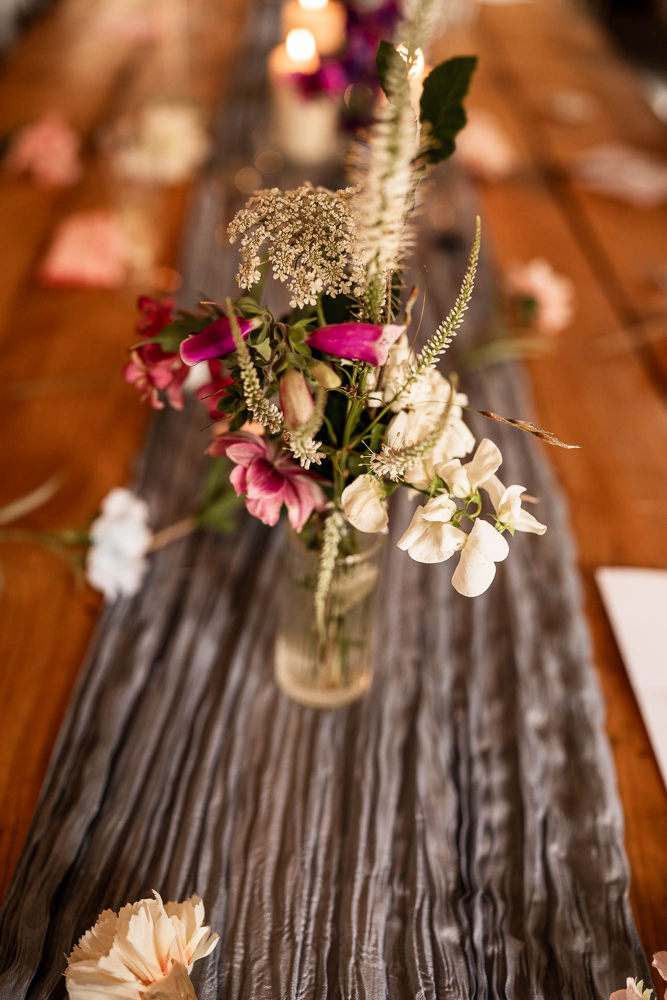 Rustic floral centrepiece on wooden reception table at Wonwood Barton wedding