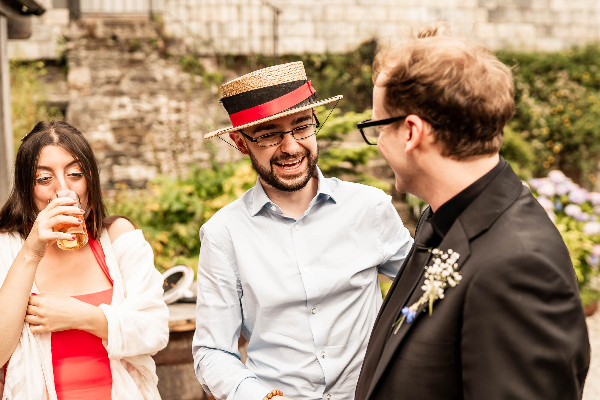 Groom laughing with guests during drinks reception at Wonwood Barton in Devon
