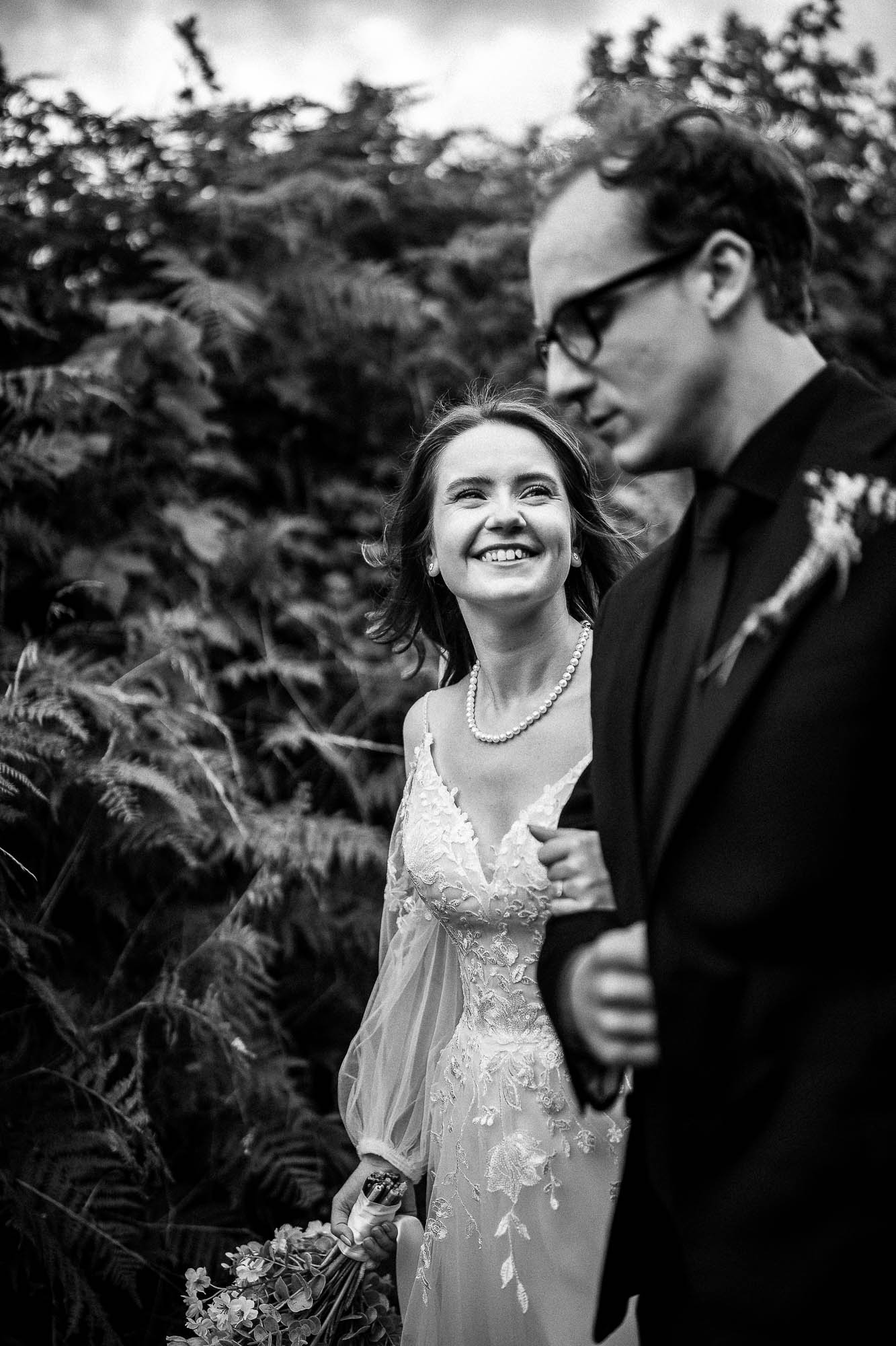 Bride smiling at groom during relaxed wedding portraits at Wonwood Barton