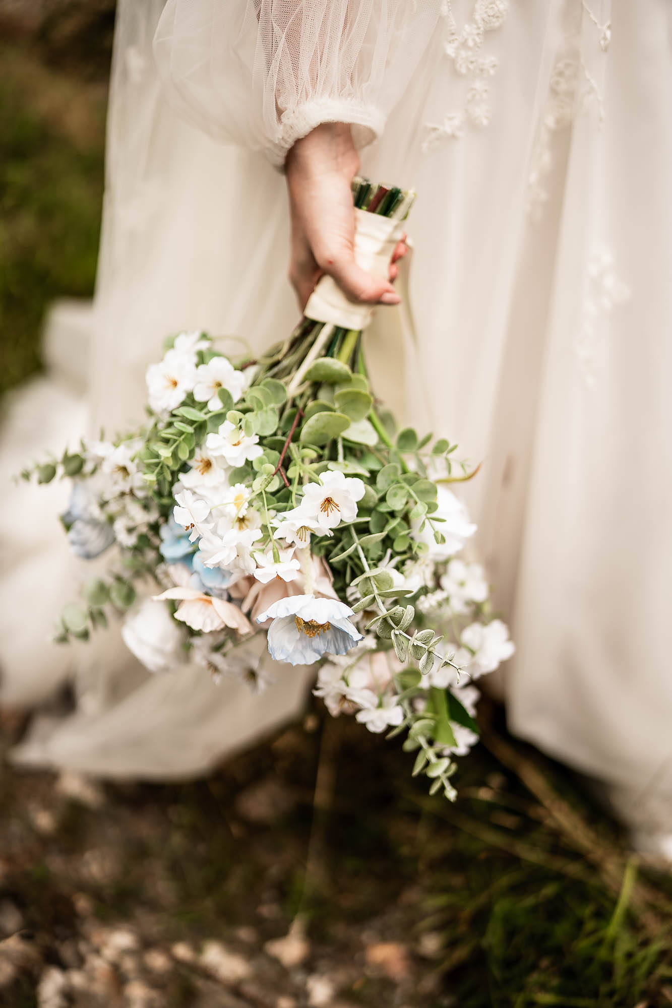 Bride holding wildflower bouquet during Wonwood Barton wedding in Devon