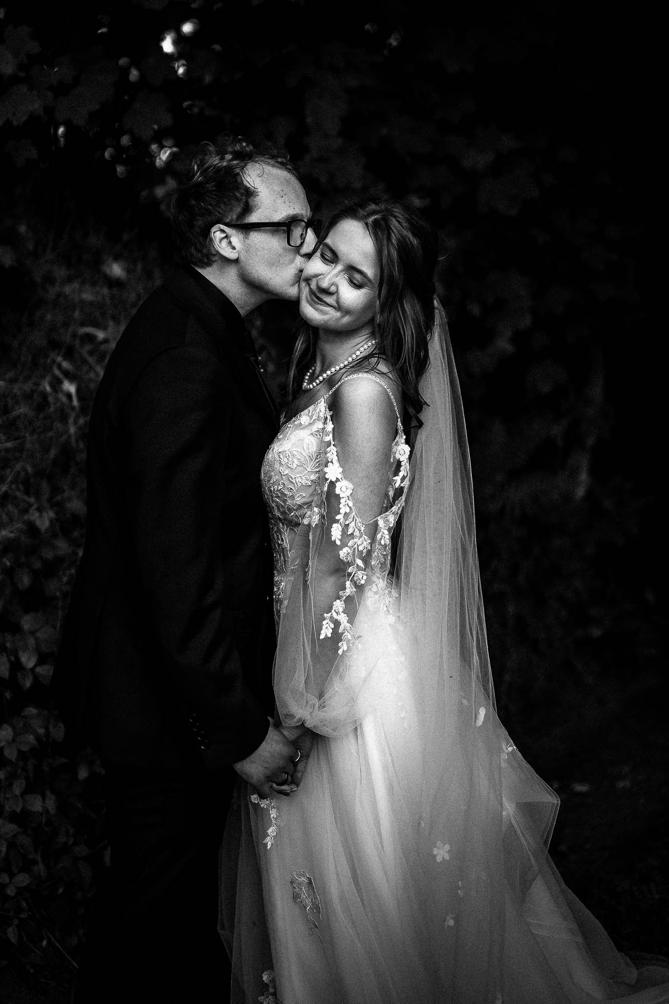 Groom kissing bride during intimate wedding portraits at Wonwood Barton